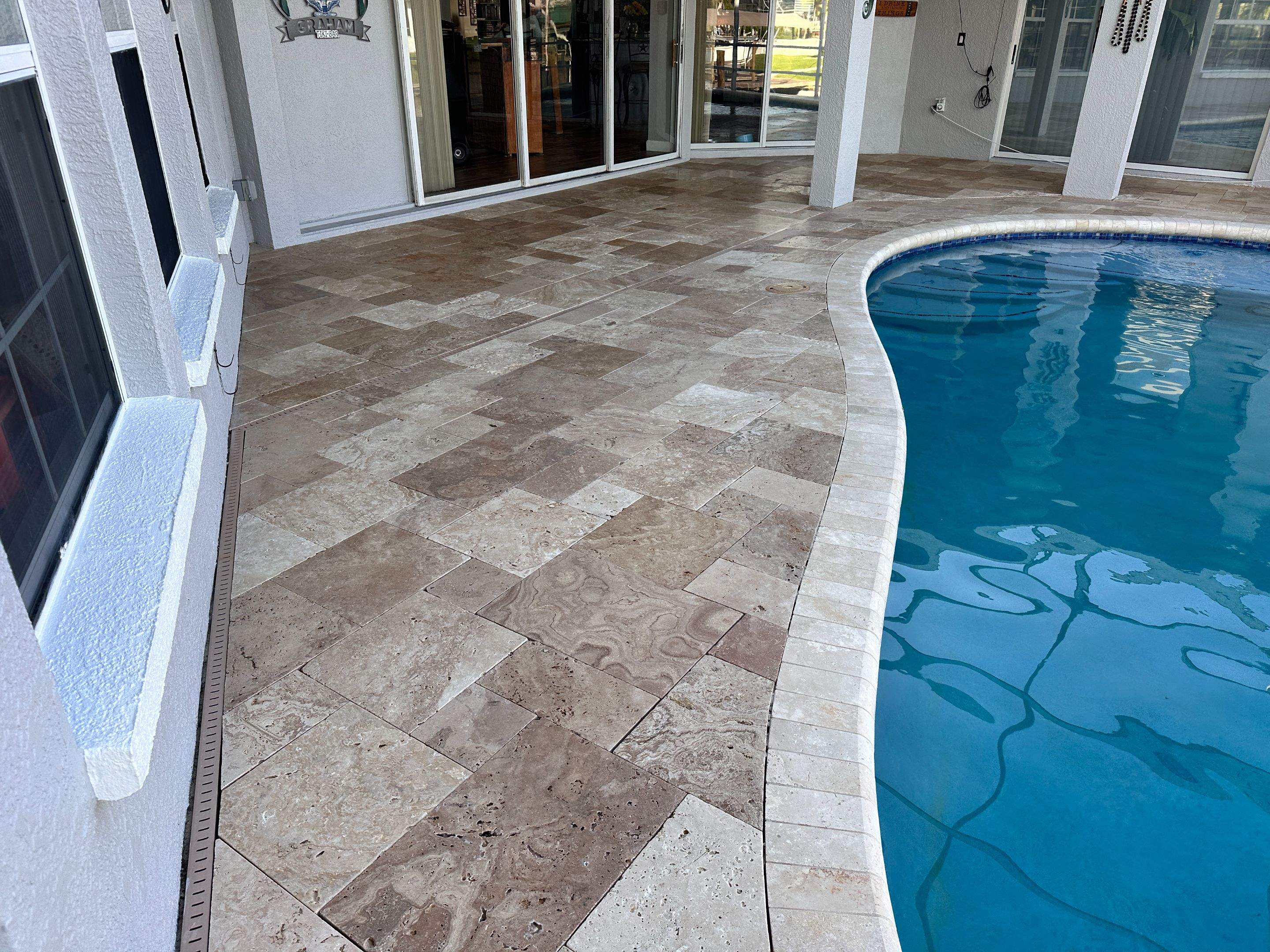 Travertine Sealing and Stripping for a Waterfront Pool Deck in Apollo Beach by Supreme Paver Experts