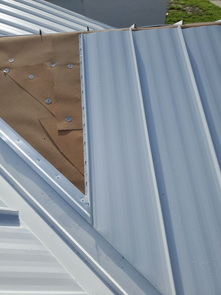 Residential Roofing Installation using 1.5" Nail Strip 24ga Solar White Kynar Coated Standing Seam Metal Panels by Morton Roofing, Inc.