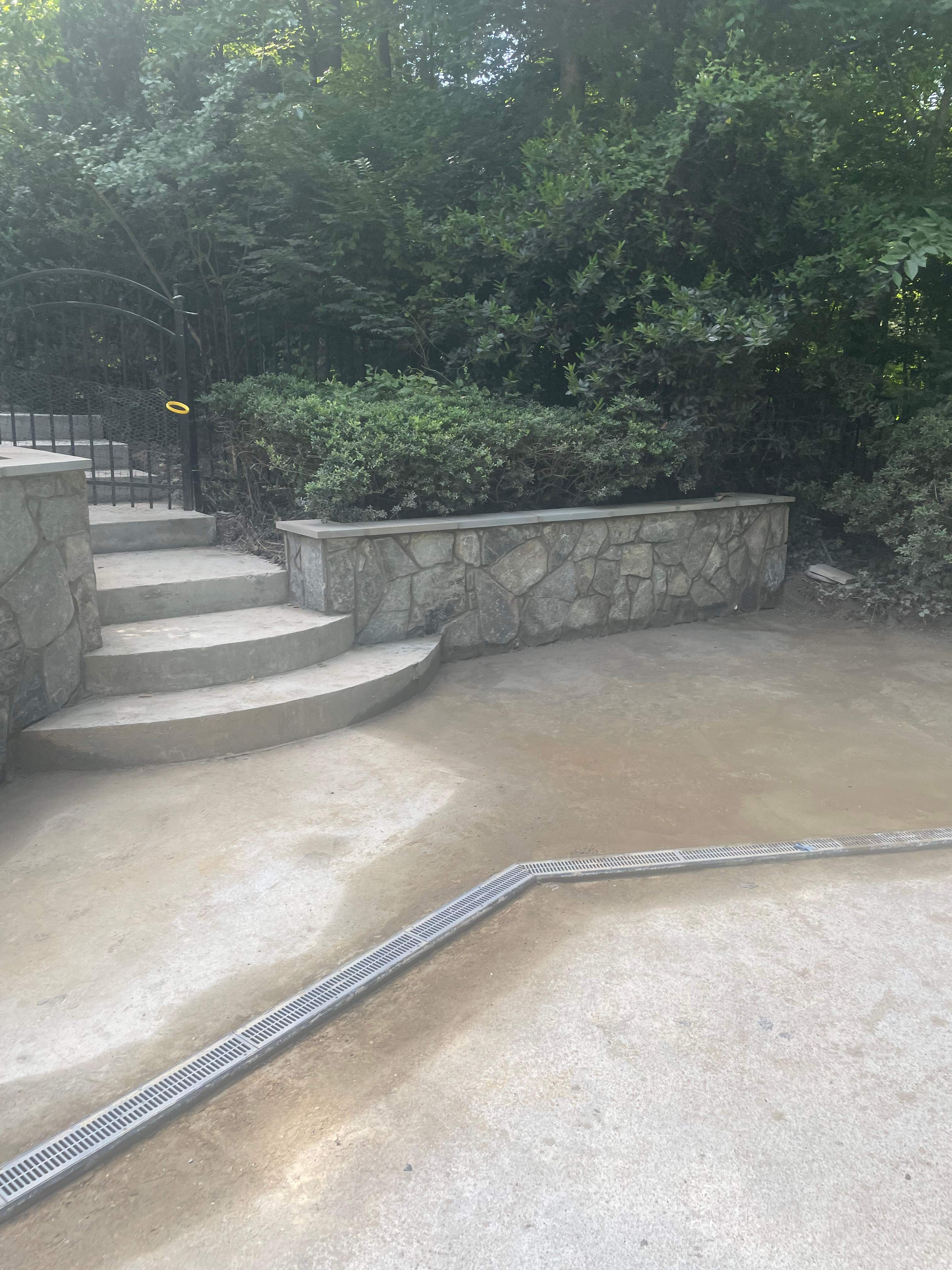 Pool Surround remodel with retaining walls, new waterfall and water slide by Fairfax Contractors, LLC
