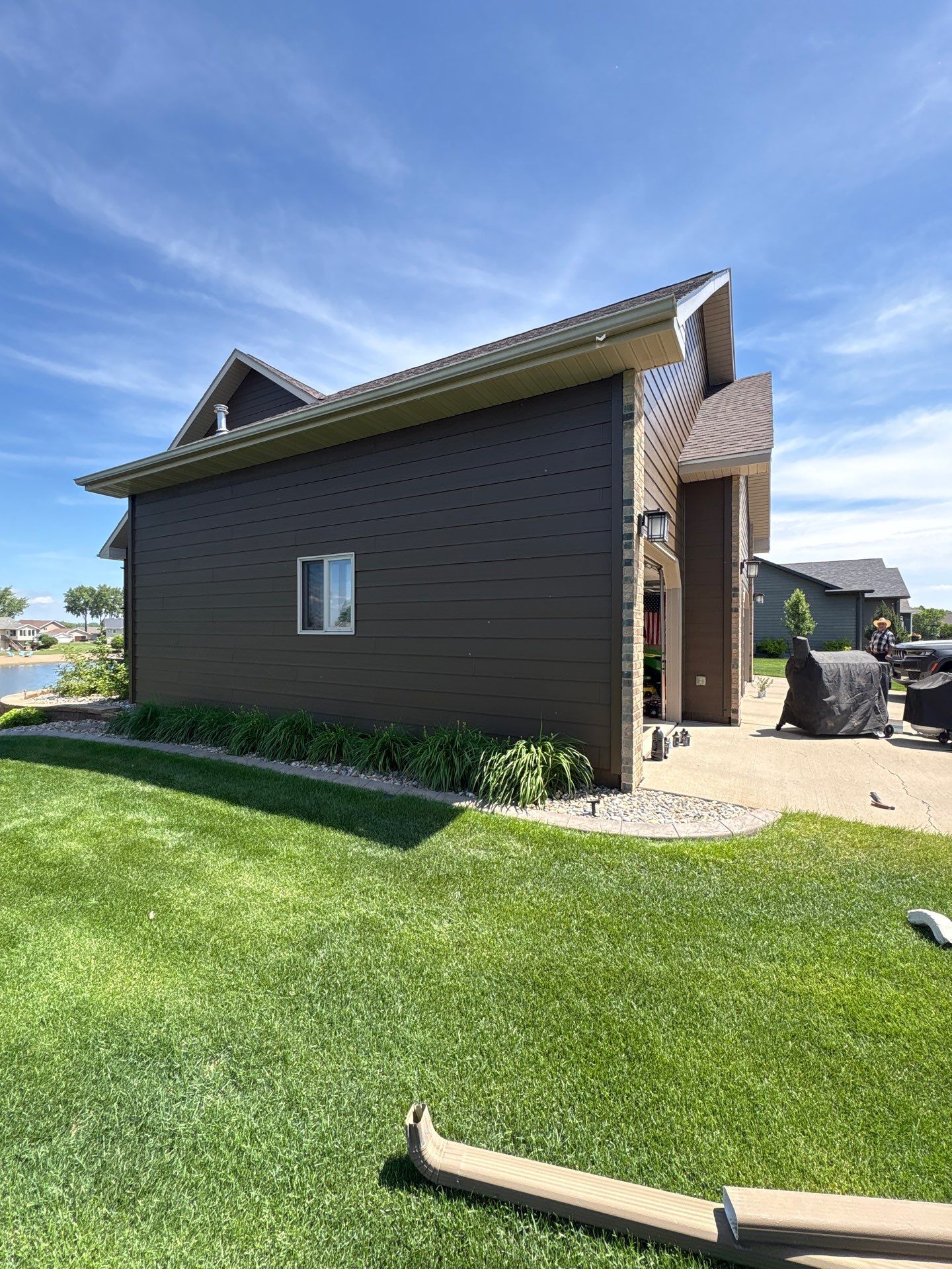 Full Exterior Renovation with Stone Veneer and Composite Decking by Select Painting, Coatings & Garage Cabinets