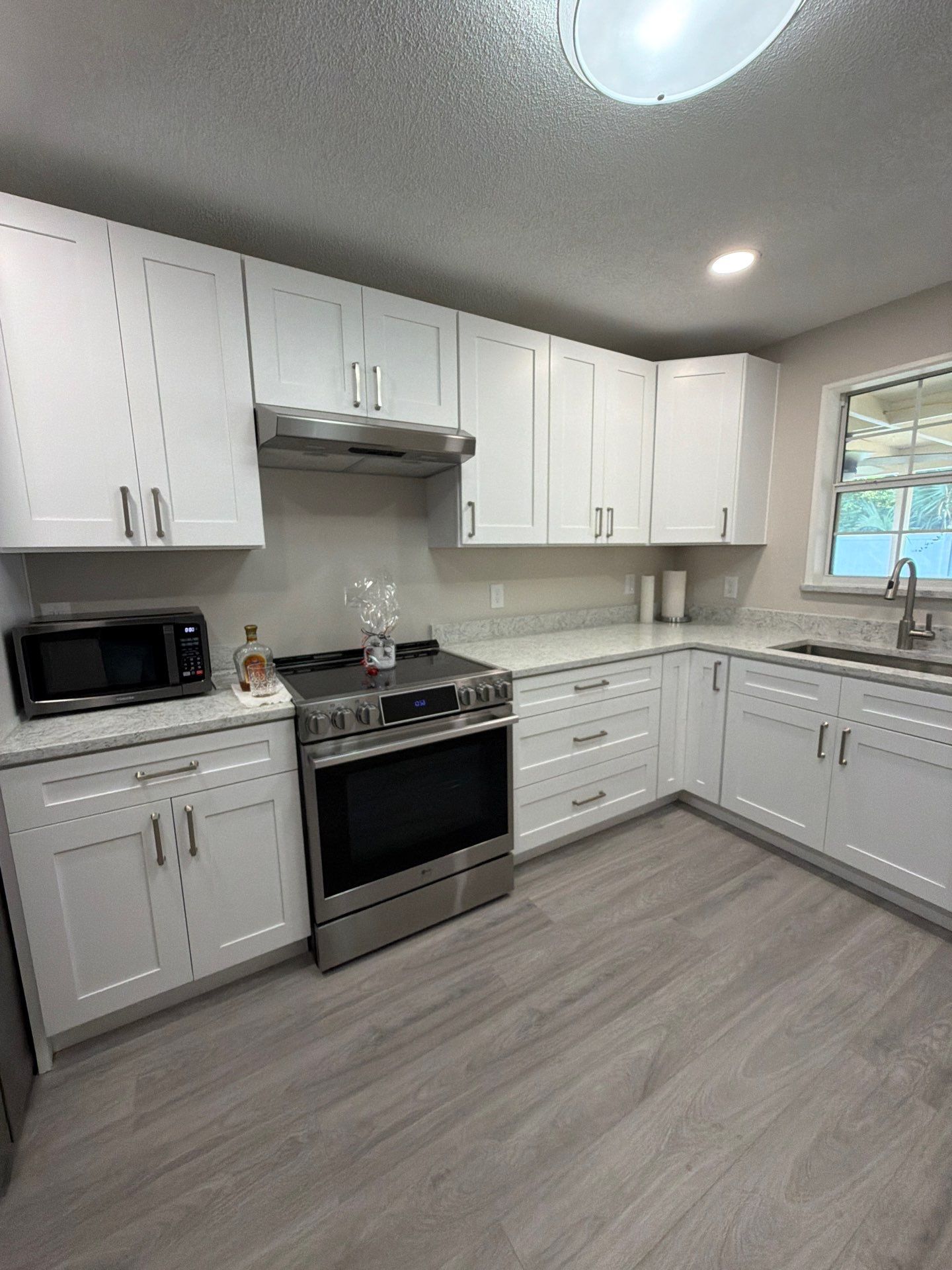 Comprehensive Home Remodel featuring Bright Modern Kitchen by Acies Renovations