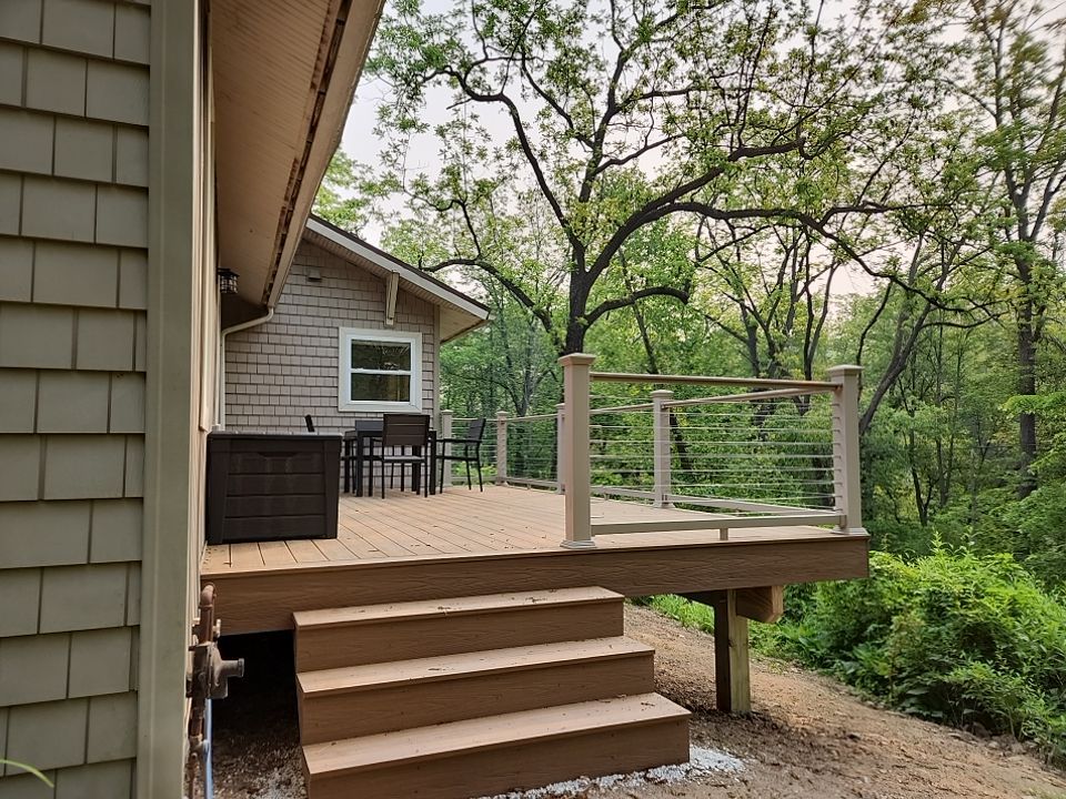Deck installation using cable railing. by Burke Home Services