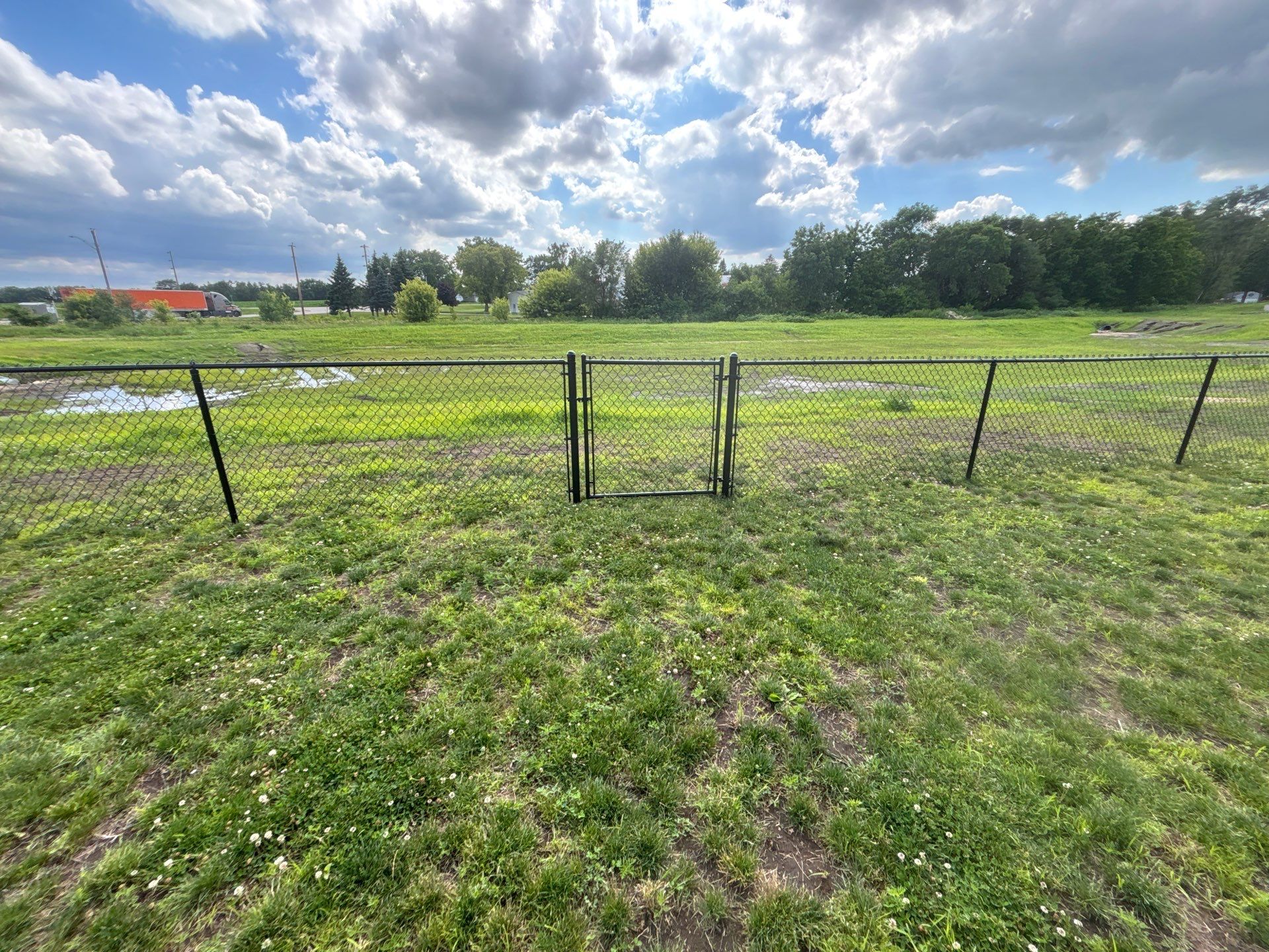Black Vinyl-Coated Chain Link Fence and Residential Site Grading by Perfect Picket Fence and Stain