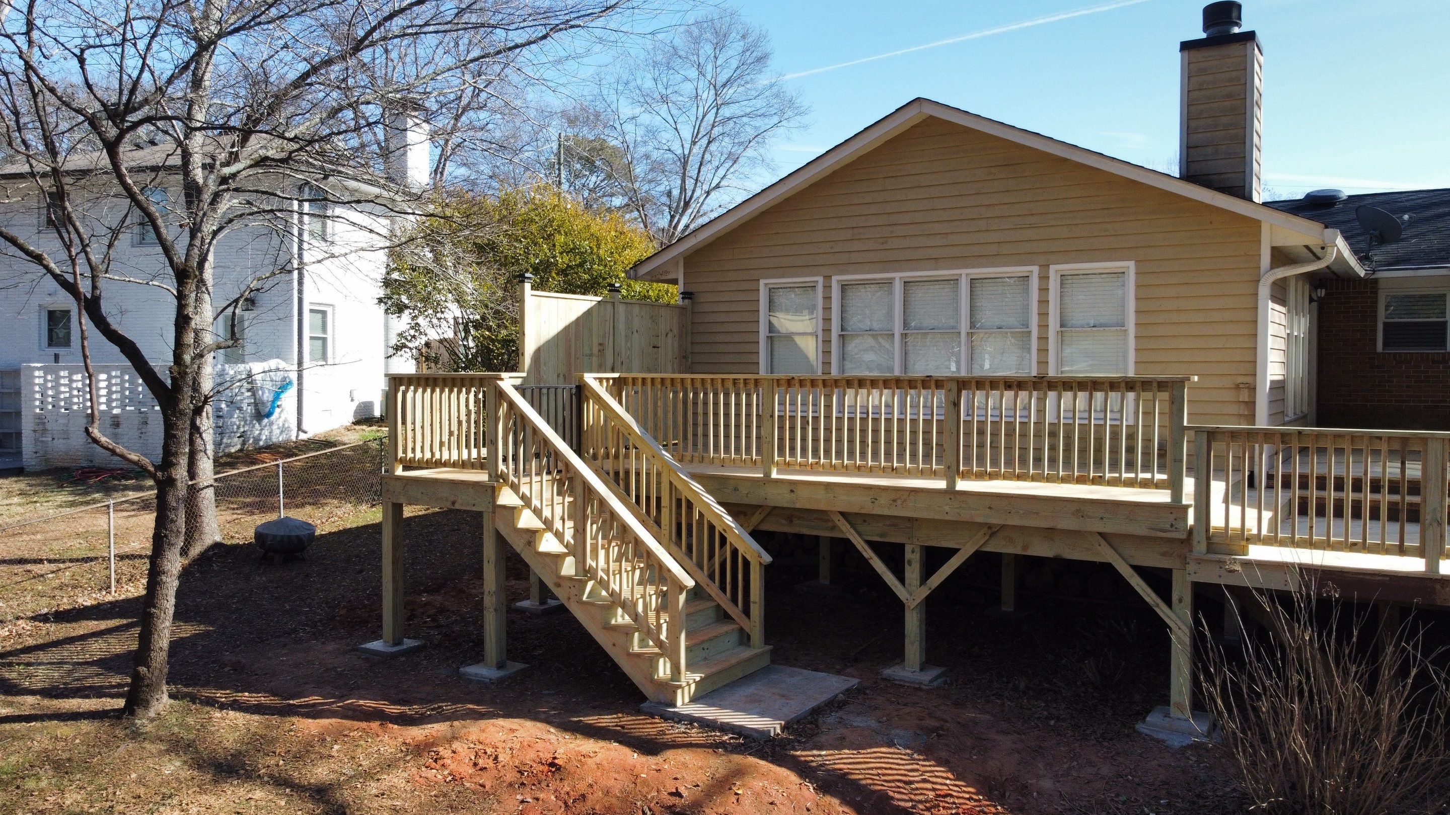 Elevated Pressure-Treated Wood Deck Extension in Marietta by Swift Home Renovations