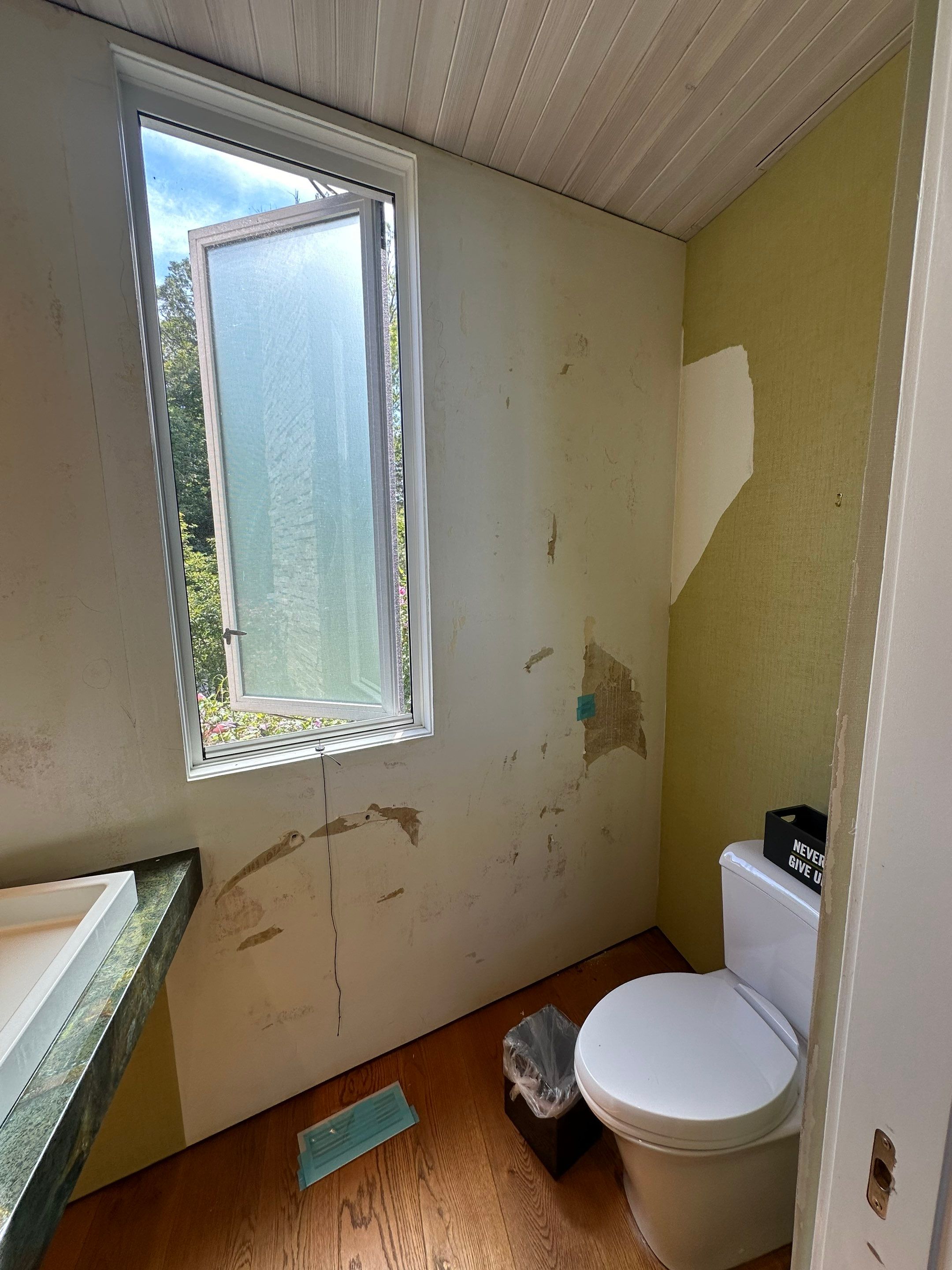 Water saturated exterior wall in half bathroom by BlueRed Restoration