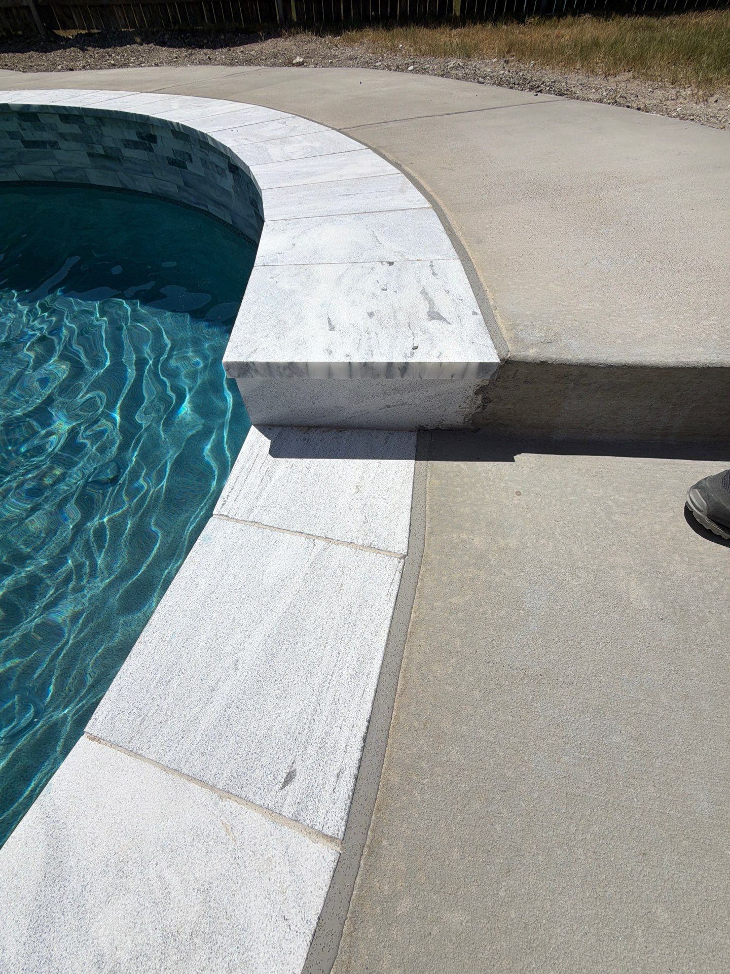 Freeform Pool with Tanning Ledge and Raised Stone Wall by Pinnacle Pools and Spas - DFW