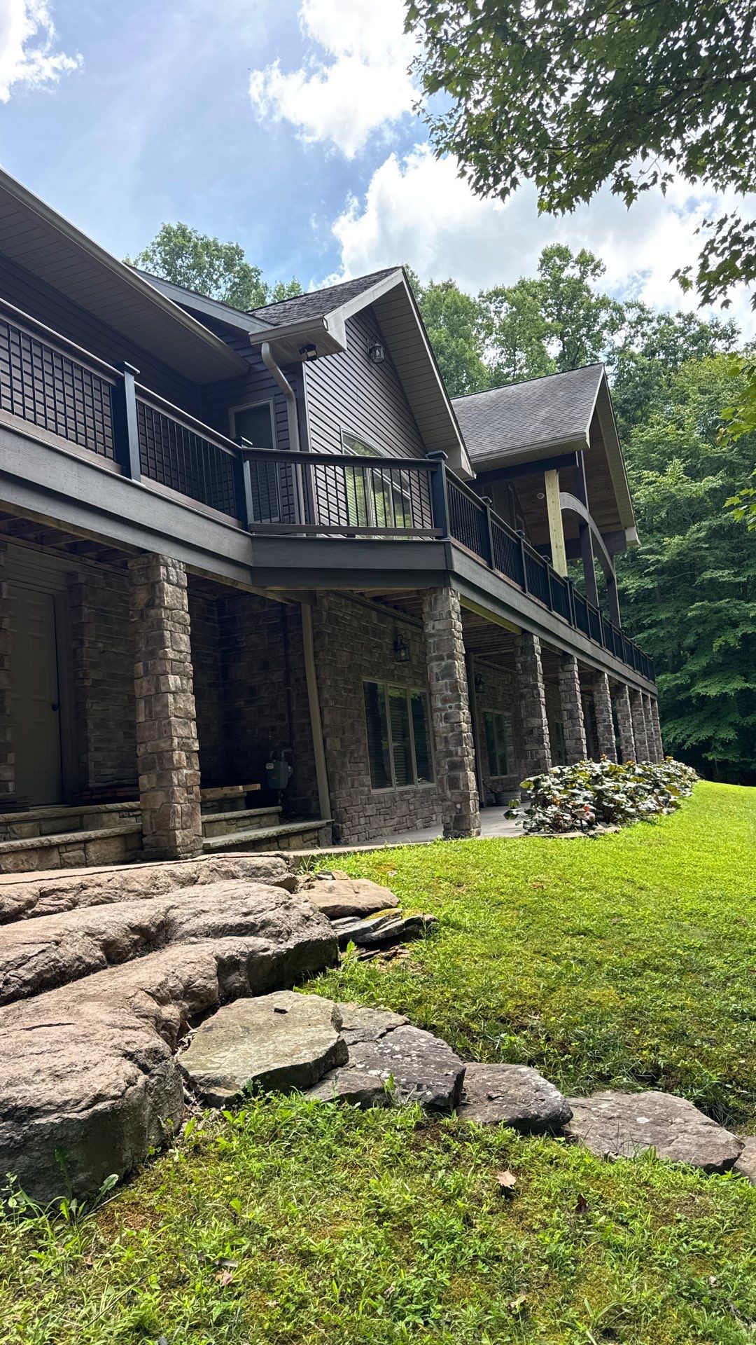 Custom Composite Deck Construction with Stone Pillars in Fayetteville by Walnut Hollow Decks & Outdoor Living