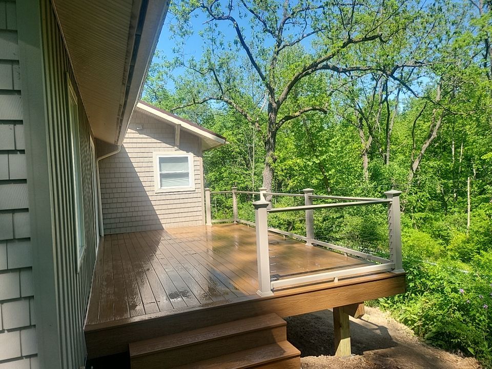 Deck installation using cable railing. by Burke Home Services