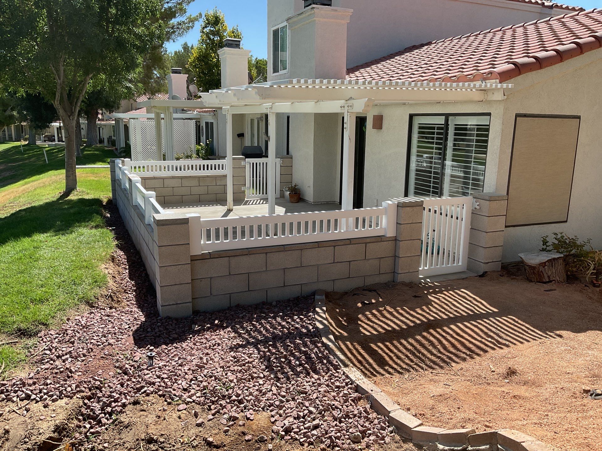 White Box Picket Fence on top of block wall  by Fence Guys Inc. 