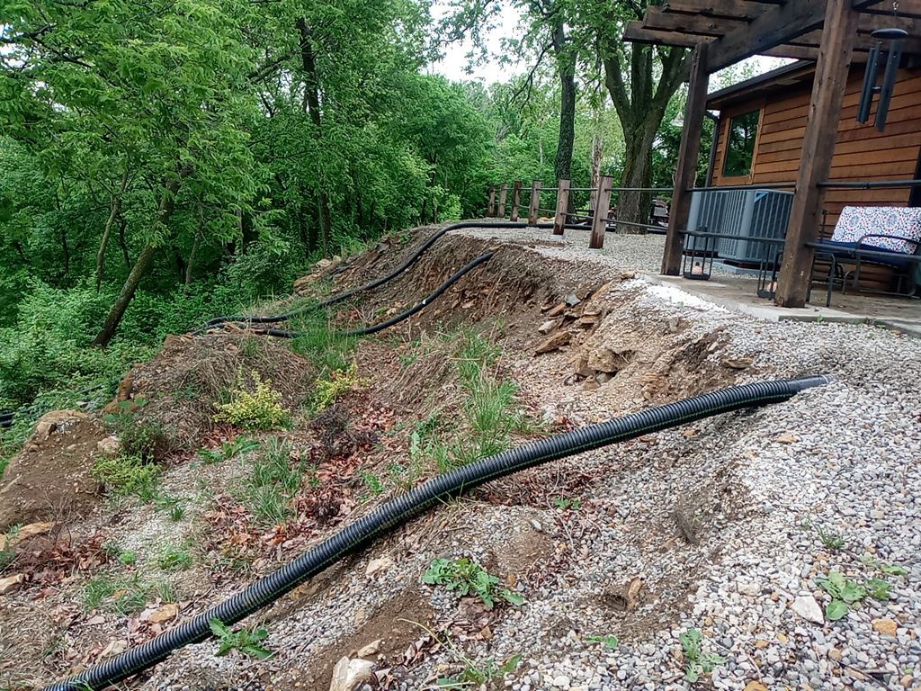 Supporting back of home with backfill at edge of steep creek by LAND ESCAPES LLC