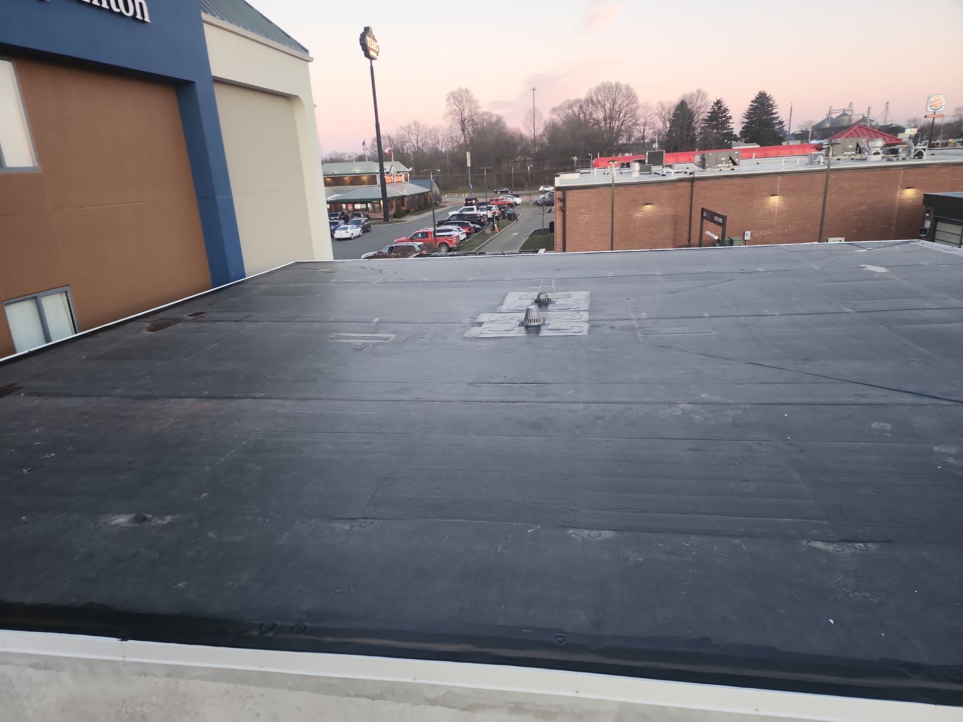 Commercial Roofing Installation using 60 mil rubber roof  by Nitro Roofing and Construction