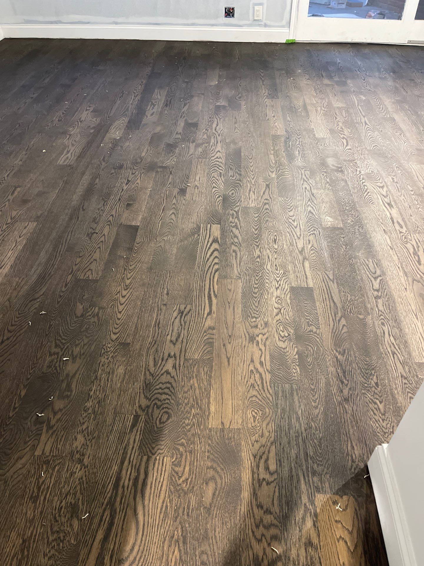 New Flooring installation using 4" White oak select grade plain sawn Ebony Stain by Ann Arbor Hardwoods