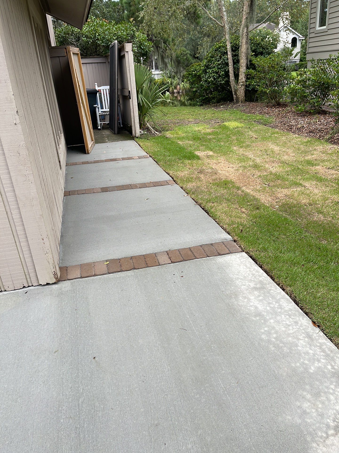 Concrete Driveway Replacement with Brick Paver Accents in Hilton Head Island by Lowcountry Scapes, LLC