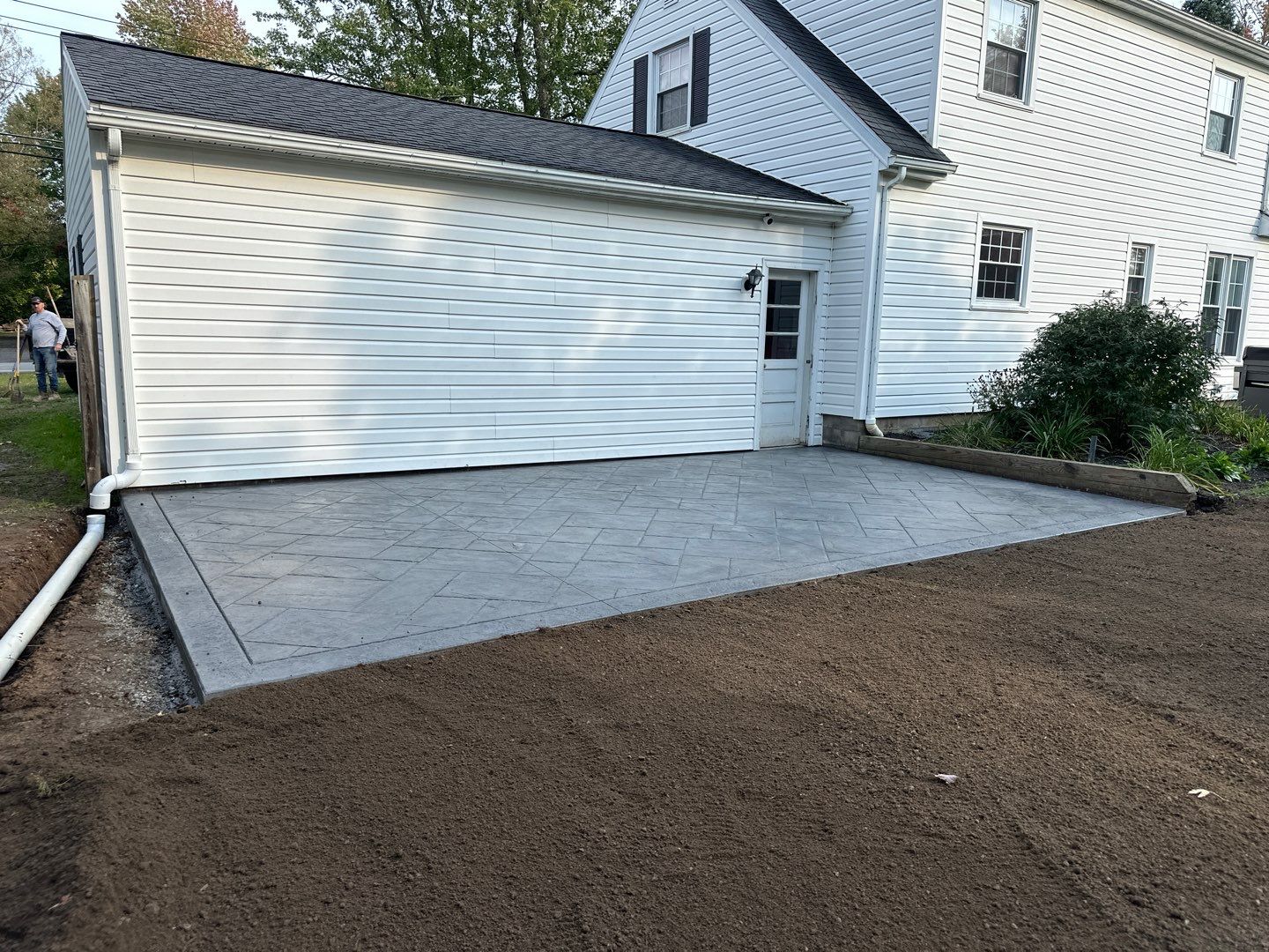 Majestic Ashlar stamped concrete patio with a border  by NG Masonry & Construction LLC