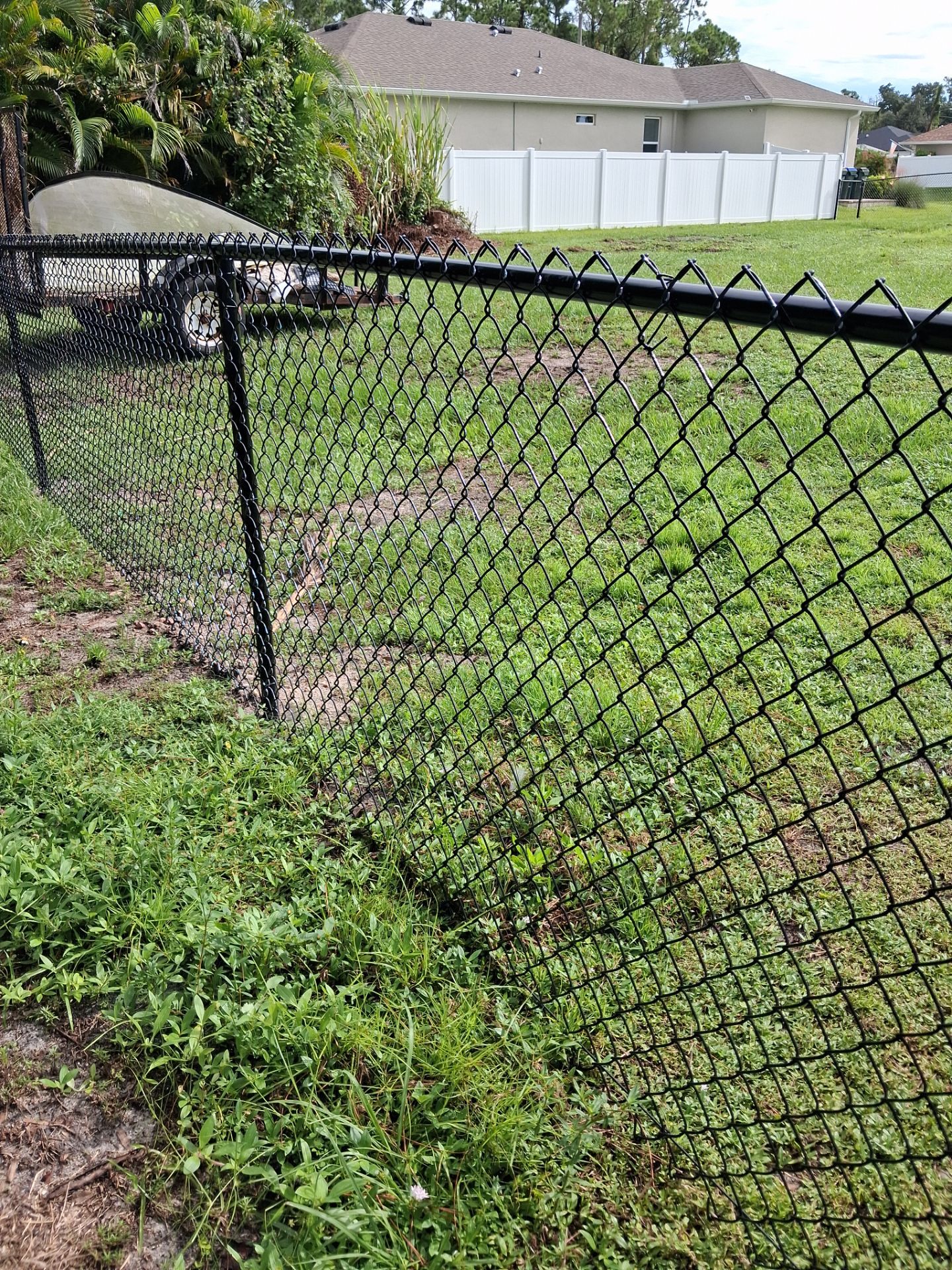 Black Chain Link Perimeter Fencing for North Port Residential Property by True Fence LLC