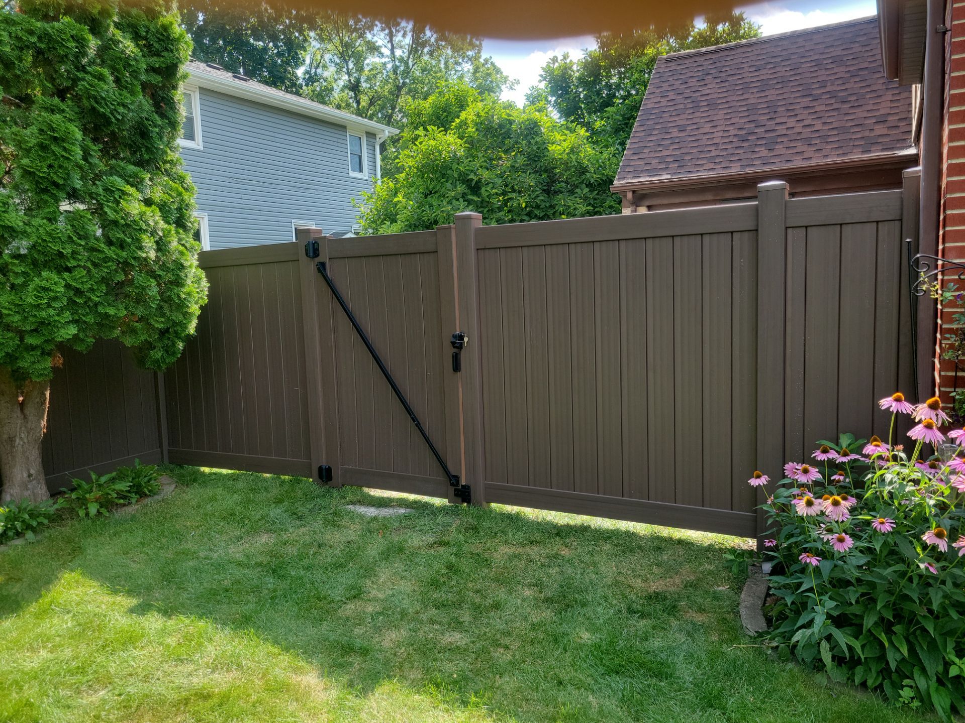 Walnut Vinyl Privacy Fence Installation in Waterloo by Perfect Picket Fence and Stain