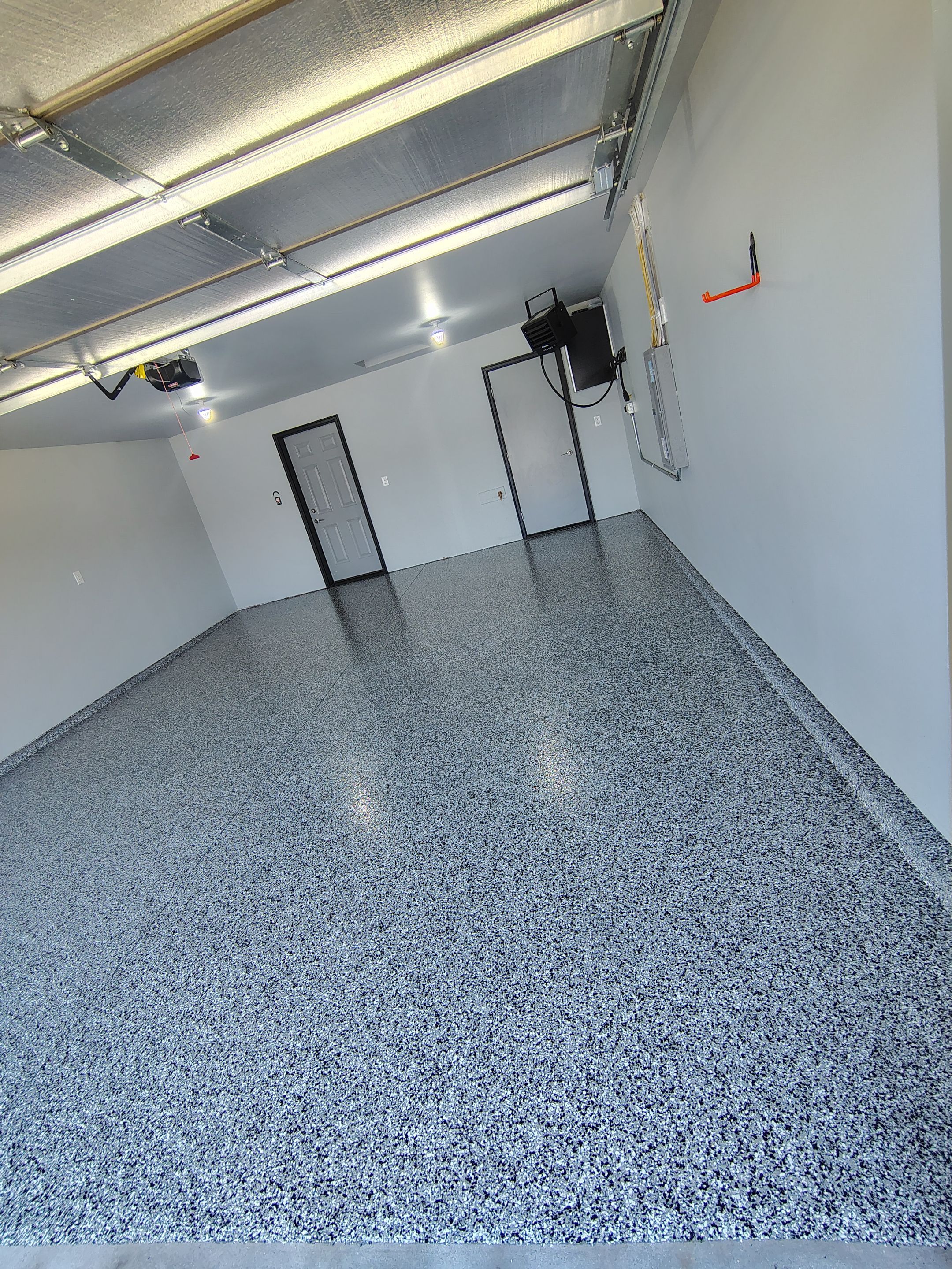 Custom Epoxy Garage Floor Coating Installation in Sioux Falls by Select Painting, Coatings & Garage Cabinets
