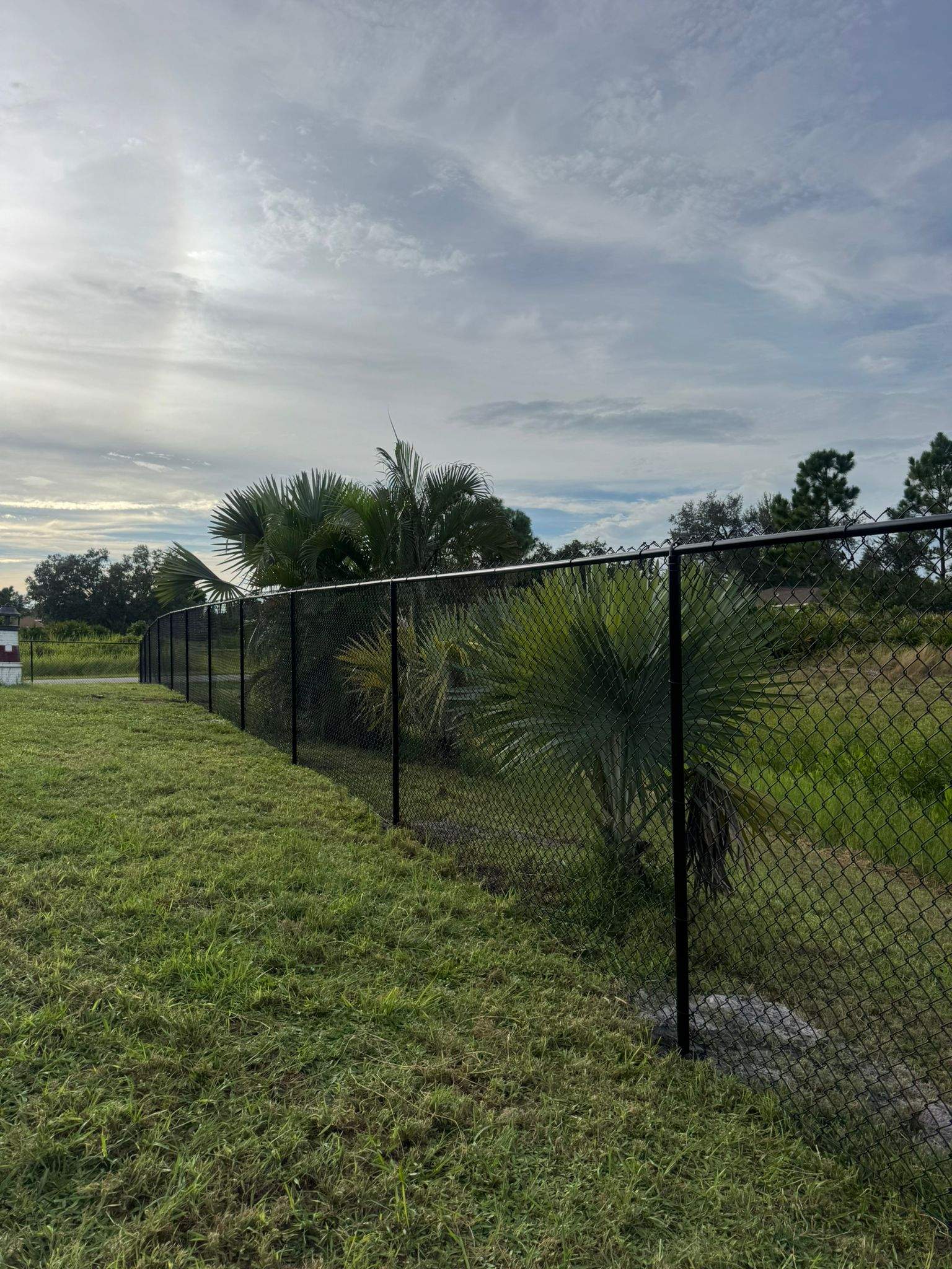 Black Vinyl-Coated Chain Link Fence and Gate Installation in North Port by True Fence LLC