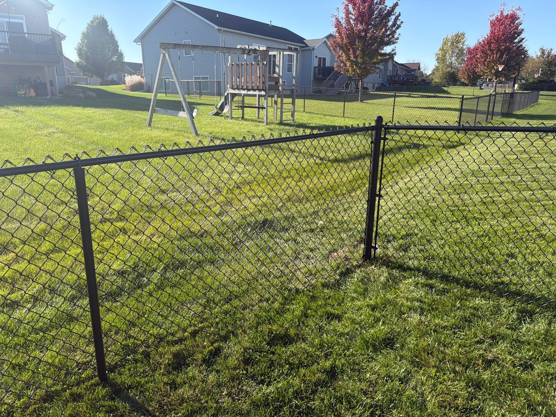 Black Vinyl-Coated Chain Link Fence Installation in Cedar Falls by Perfect Picket Fence and Stain