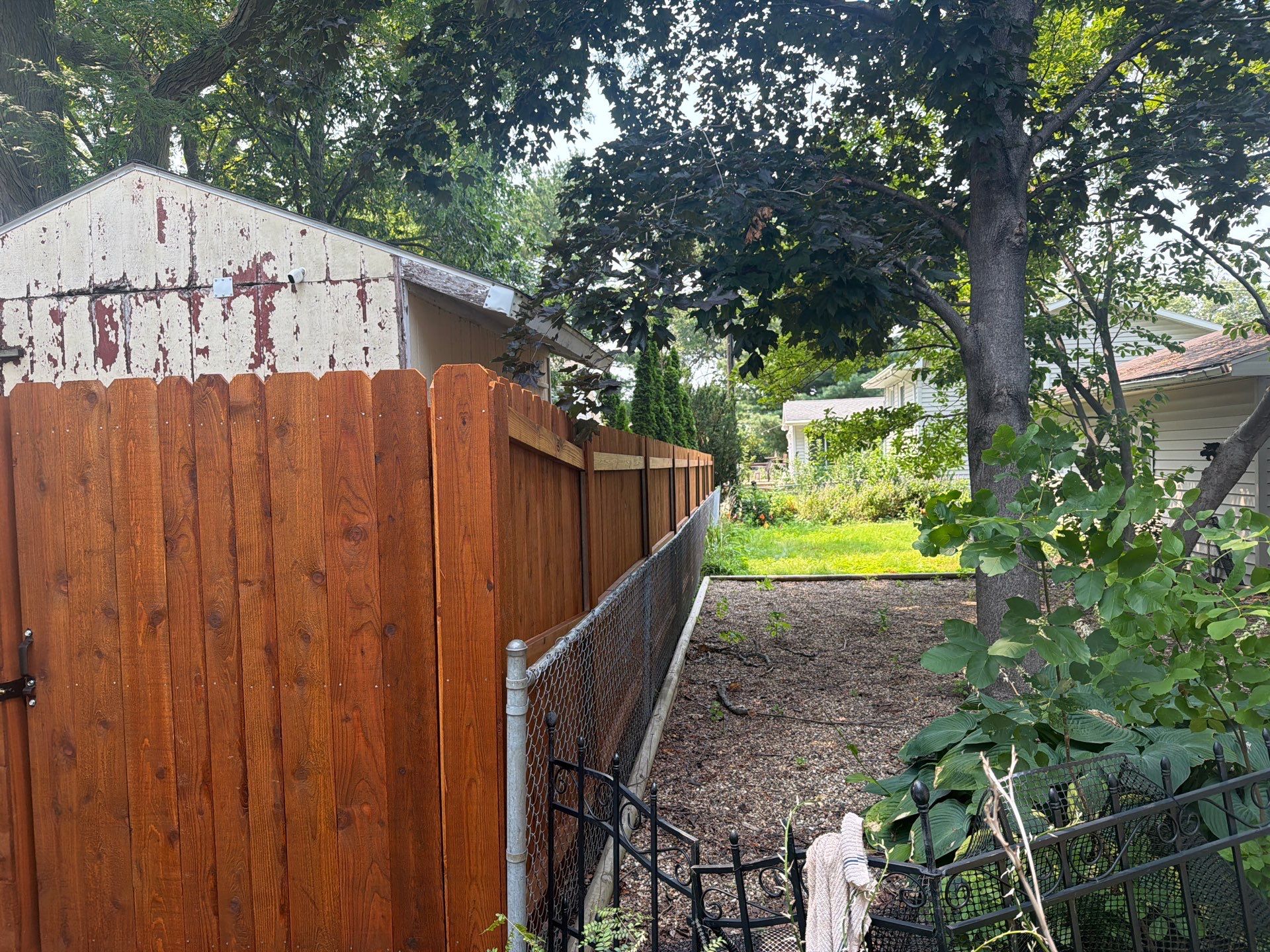 Pecan Cedar Privacy Fence Installation with Scalloped Top in Cedar Falls by Perfect Picket Fence and Stain