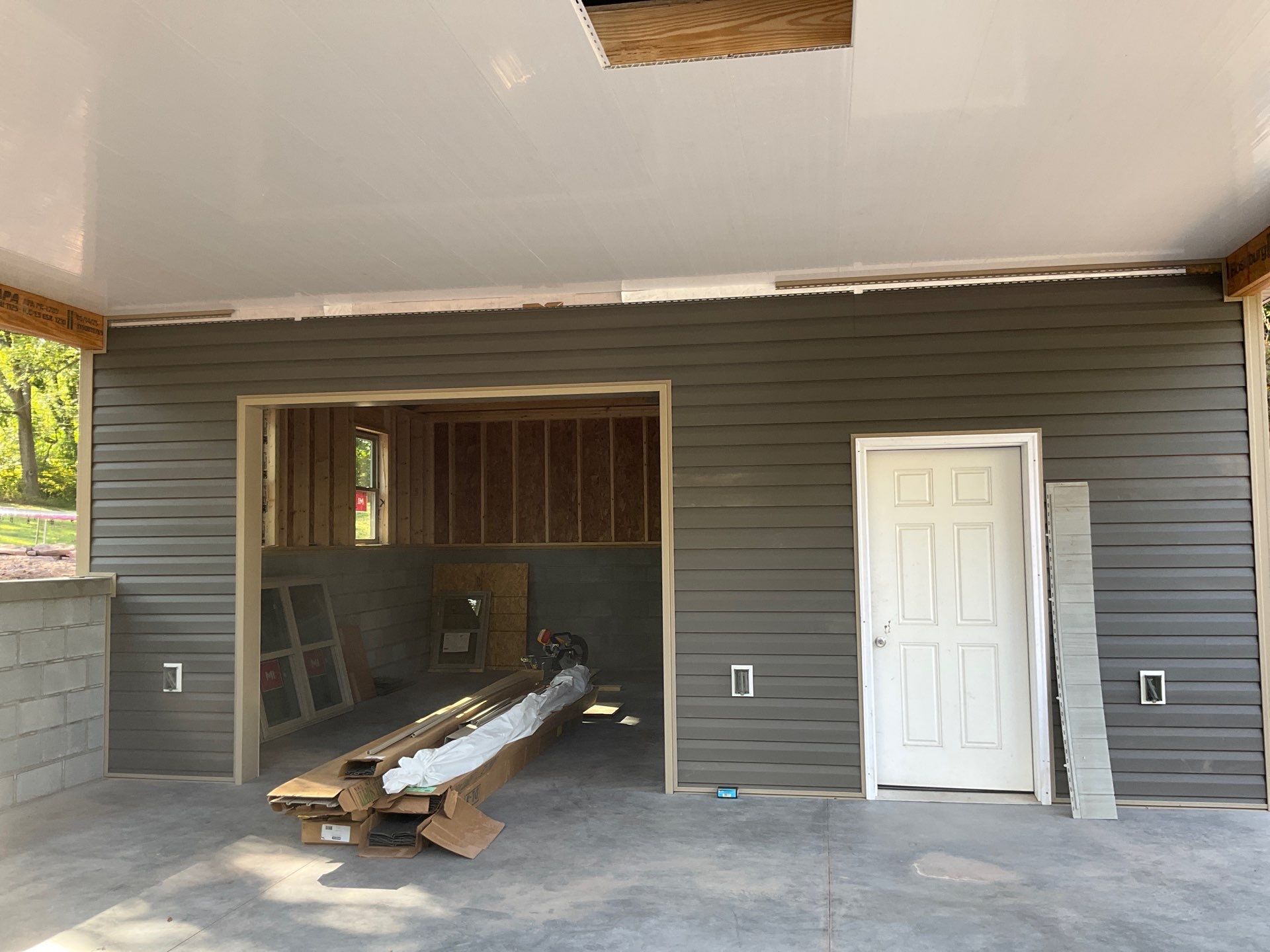 Detached Garage Construction with Vinyl Siding and Metal Roof by Esh Builders