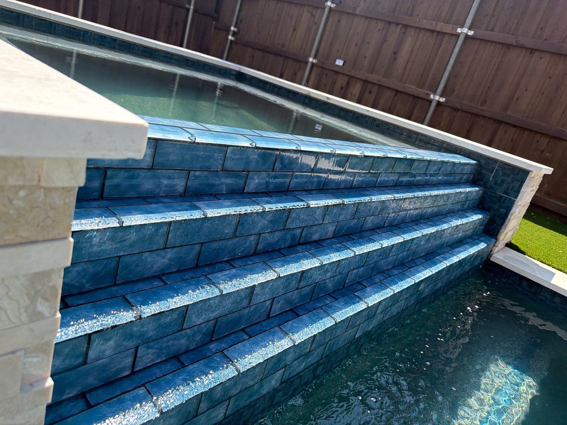 Modern Geometric Pool with Tile Waterfall Wall and Fire Bowls by Pinnacle Pools and Spas - DFW