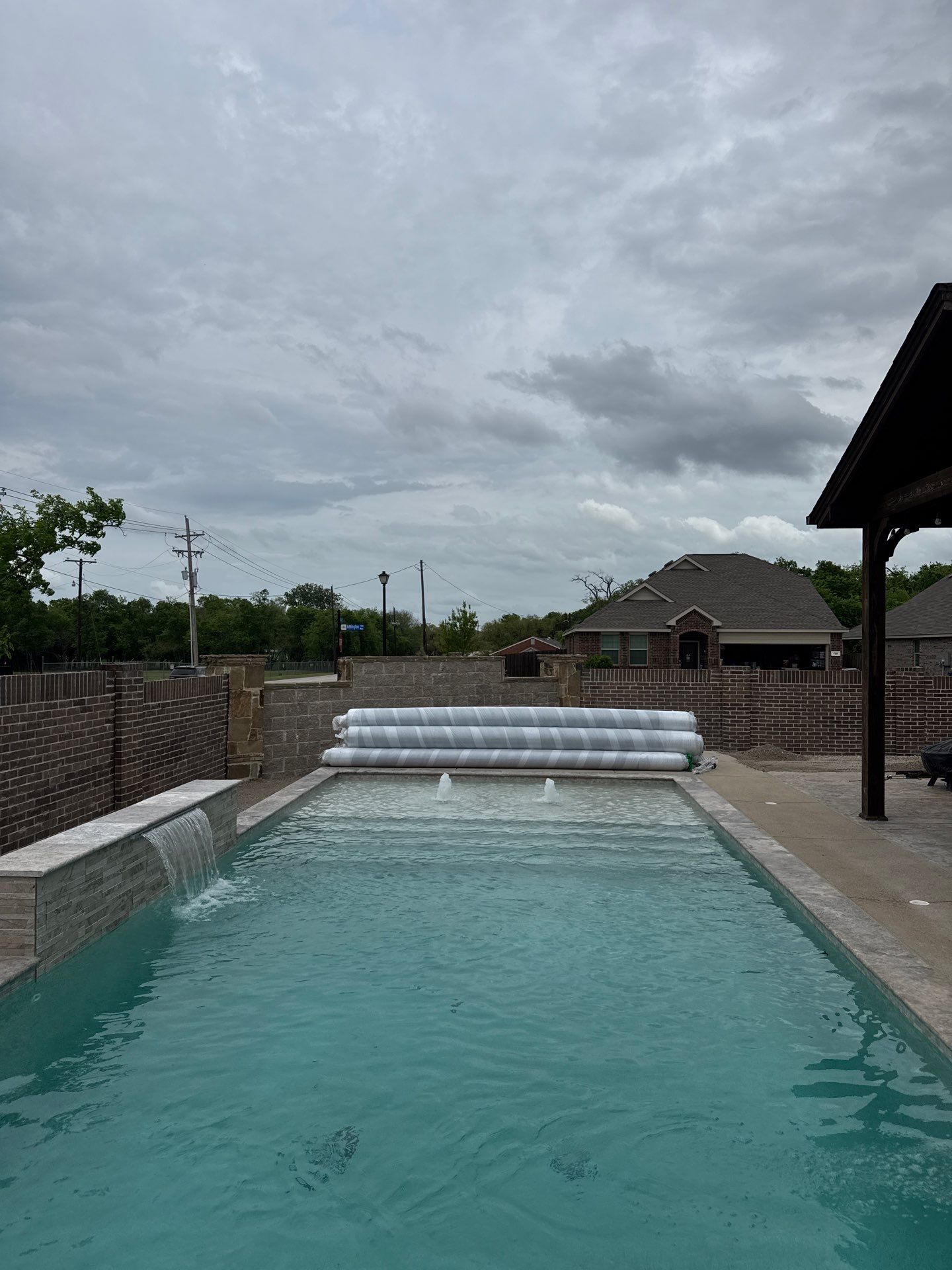 Rectangular Pool with Tanning Ledge and Waterfall by Pinnacle Pools and Spas - DFW