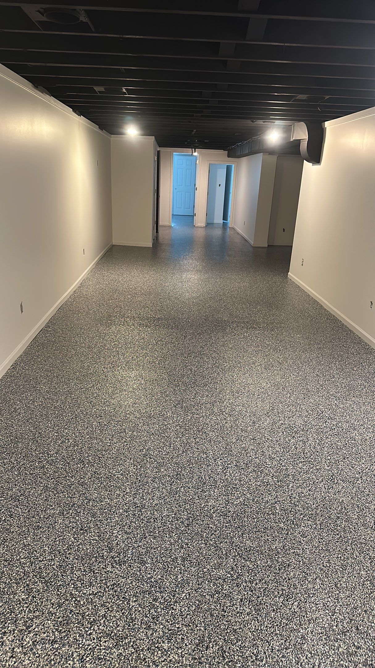 A beautiful Banner Garage Coating in a basement  by Banner Garage