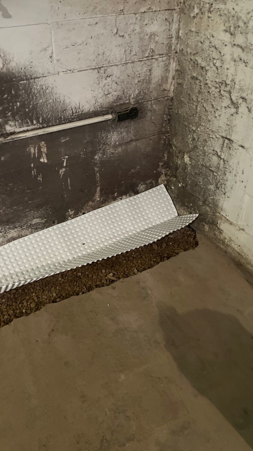 Interior drain tile system installation by ACE Waterproofing & Basement Solutions