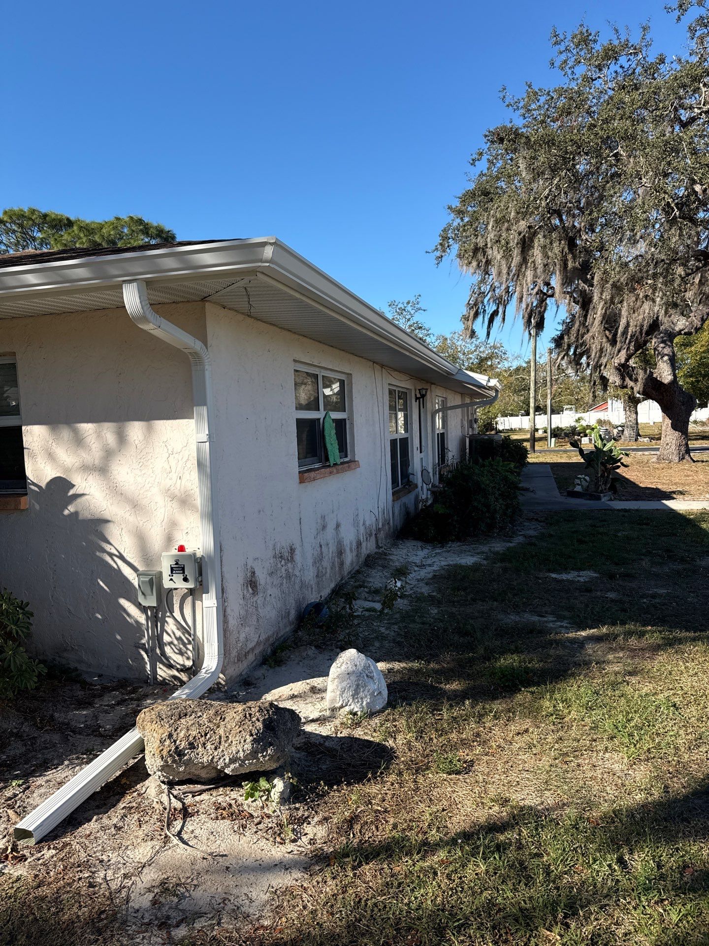 Downspout Installation using White Down Spouts in Sarasota FL by Gutter Professors