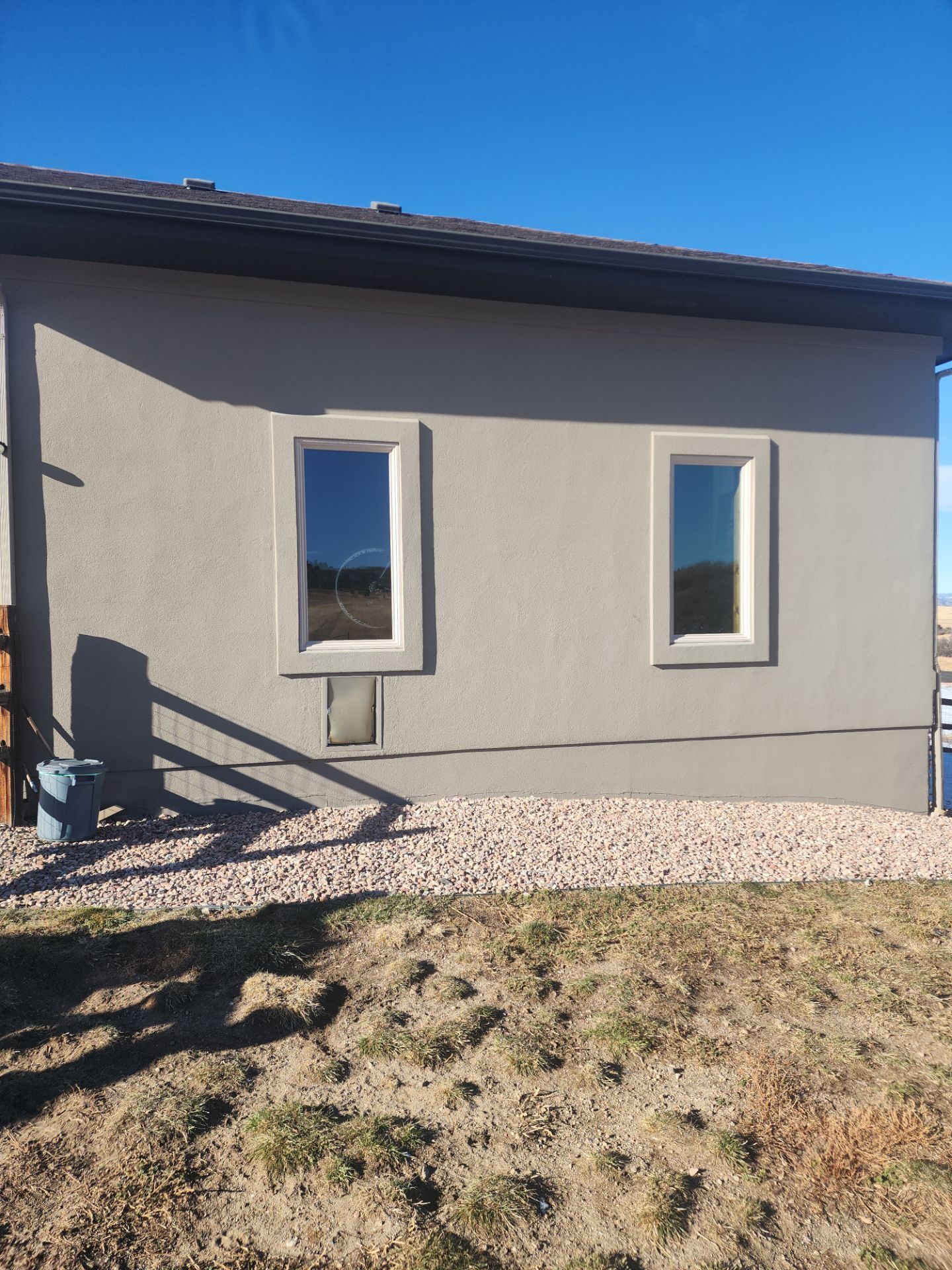 Castle Rock Elegance: White Stucco Exterior with Bold Tricorn Black by J&M Painting LLC