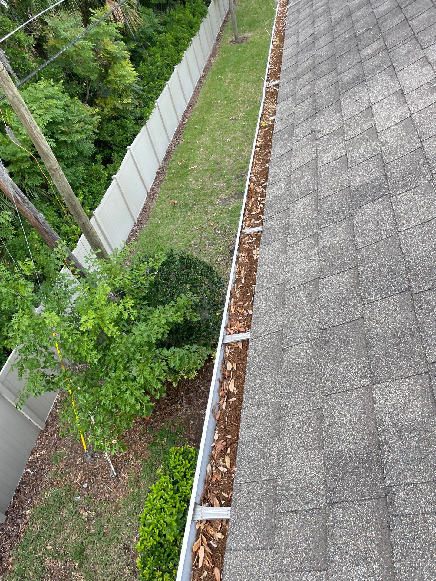 Commercial gutter cleaning Sanford & Lake Mary, FL before photo with filled gutters