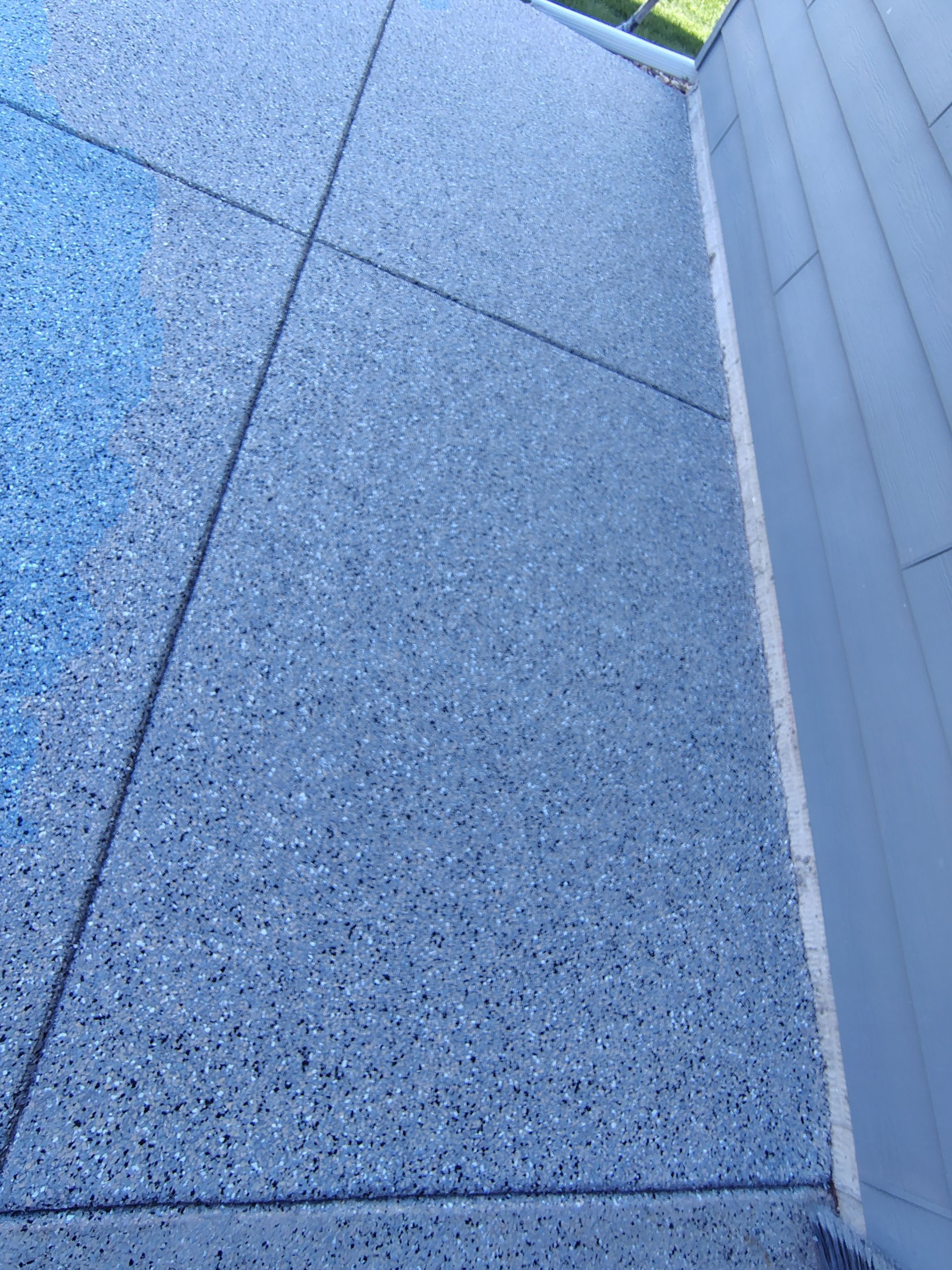 Speckled Concrete Patio Coating Installation in Sioux Falls by Select Painting, Coatings & Garage Cabinets