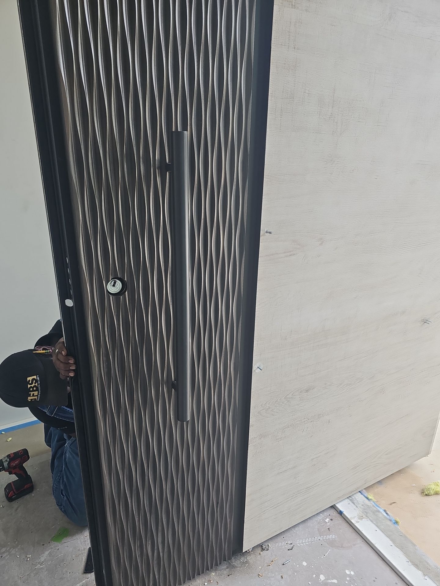 This stunning custom pivot door is a true statement of security and luxury, installed in the heart of Boca Raton. Designed to withstand the harshest conditions, it is hurricane-certified, ensuring unparalleled strength and protection. The door features a bespoke metal finish, exuding modern elegance while complementing the surrounding architecture. A custom metal door handle enhances its unique aesthetic, blending seamlessly with the door’s bold presence. Beyond its striking appearance, this door is equipped with advanced security technology, including a motorized lock for effortless access control and a self-closing feature for seamless functionality. A masterpiece of craftsmanship and innovation, this installation embodies the perfect fusion of security, design, and cutting-edge automation—a true reflection of FBS’s commitment to excellence. by FBS Systems Inc