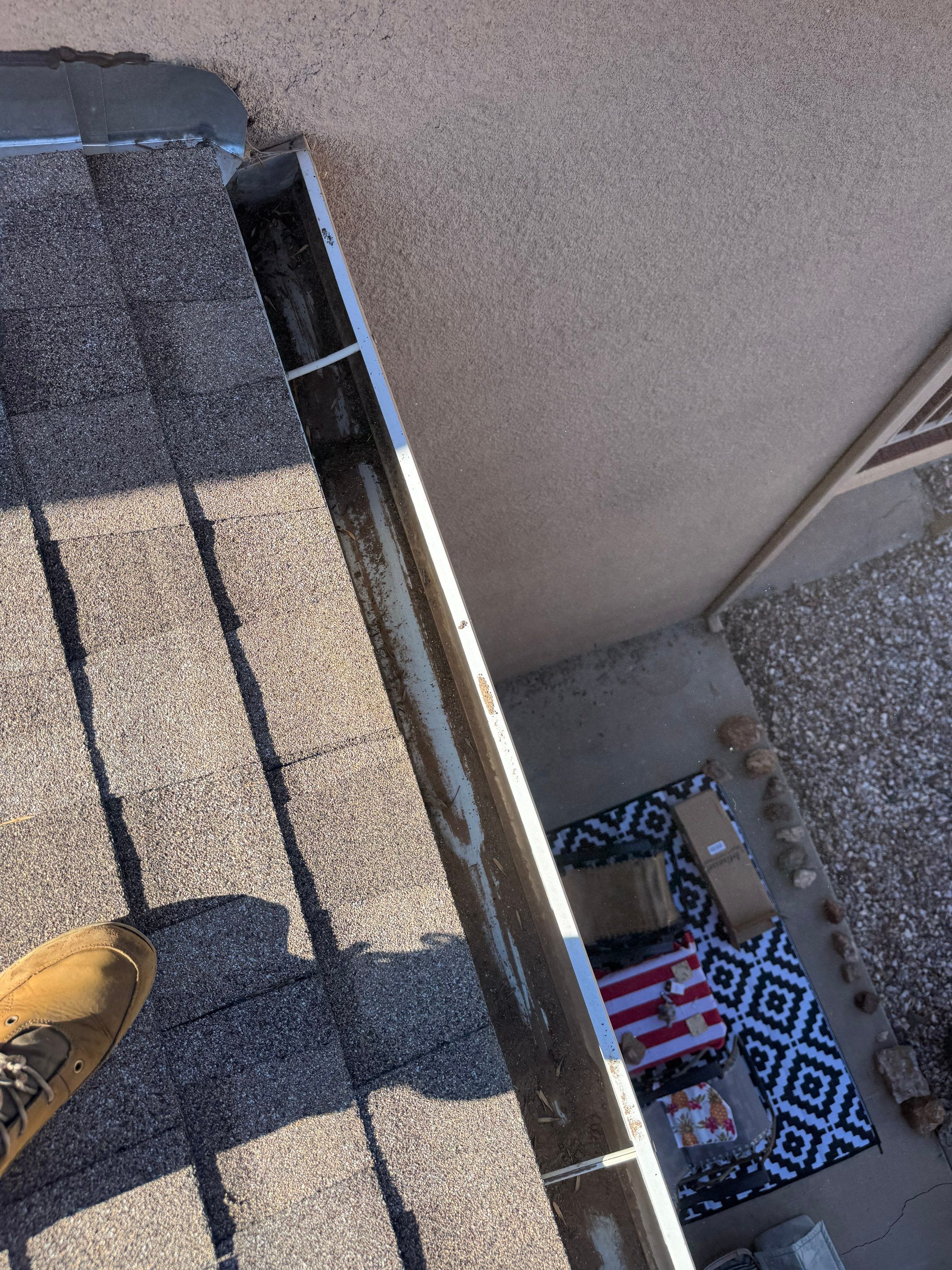 HOA gutter cleaning in Mesquite, NV, after  photo showing full gutters.