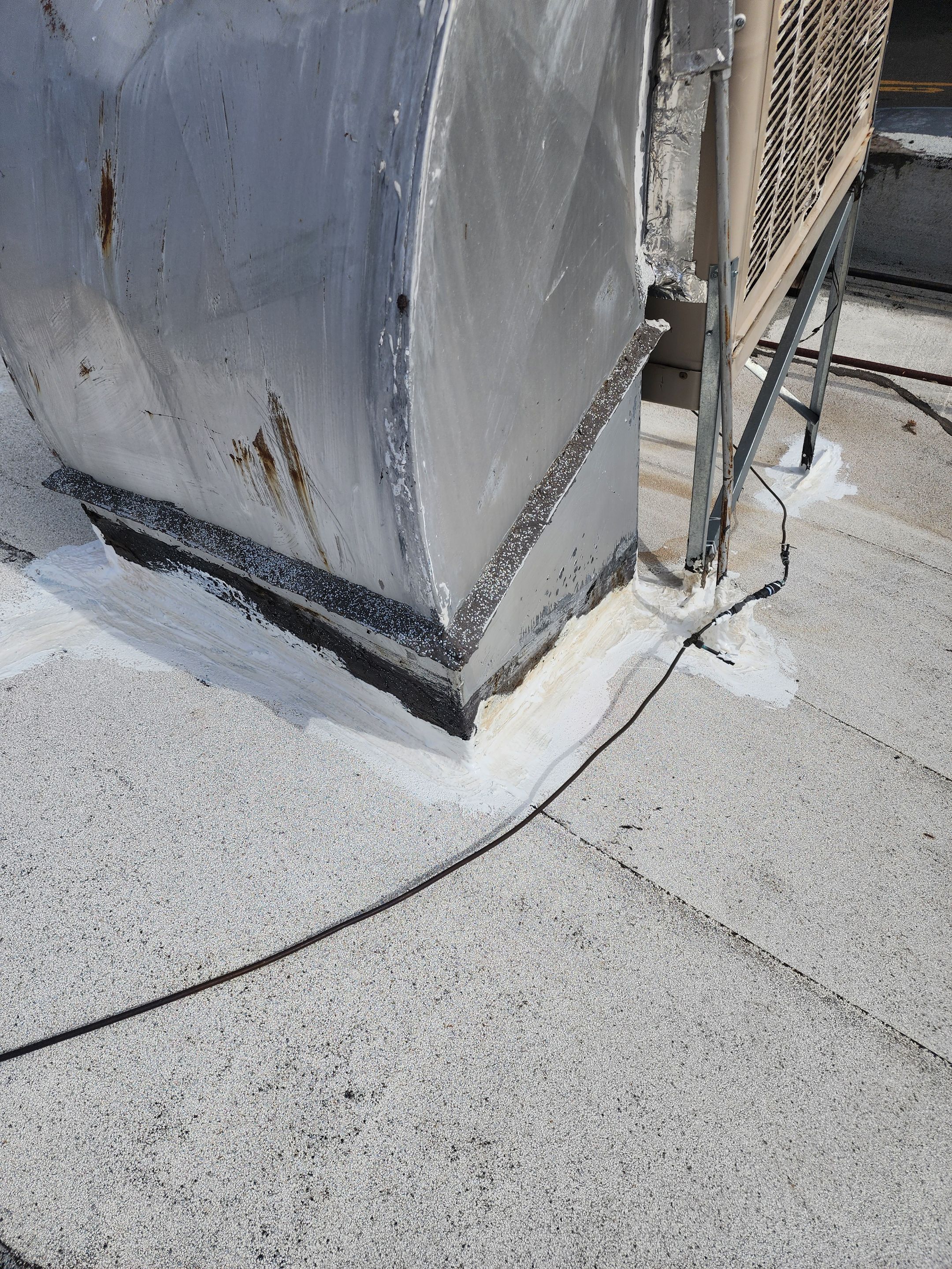 Foam and coatings on commercial roof by Straight Edge Roofing Inc