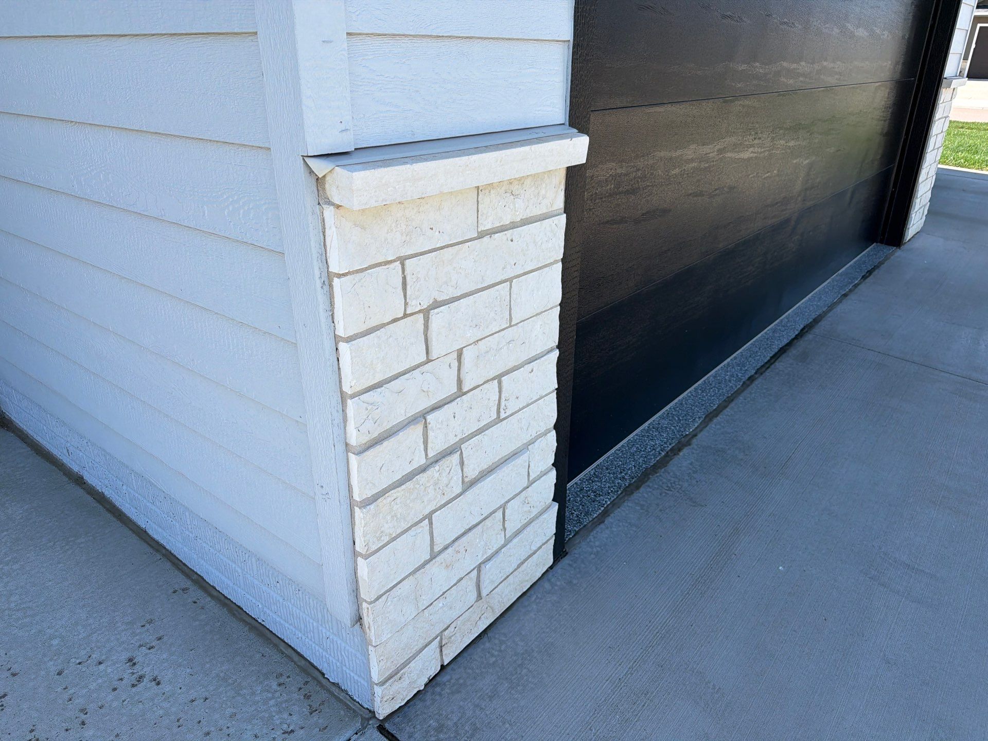 Modern Exterior Update with Siding and Stone Masonry in Sioux Falls by Select Painting, Coatings & Garage Cabinets