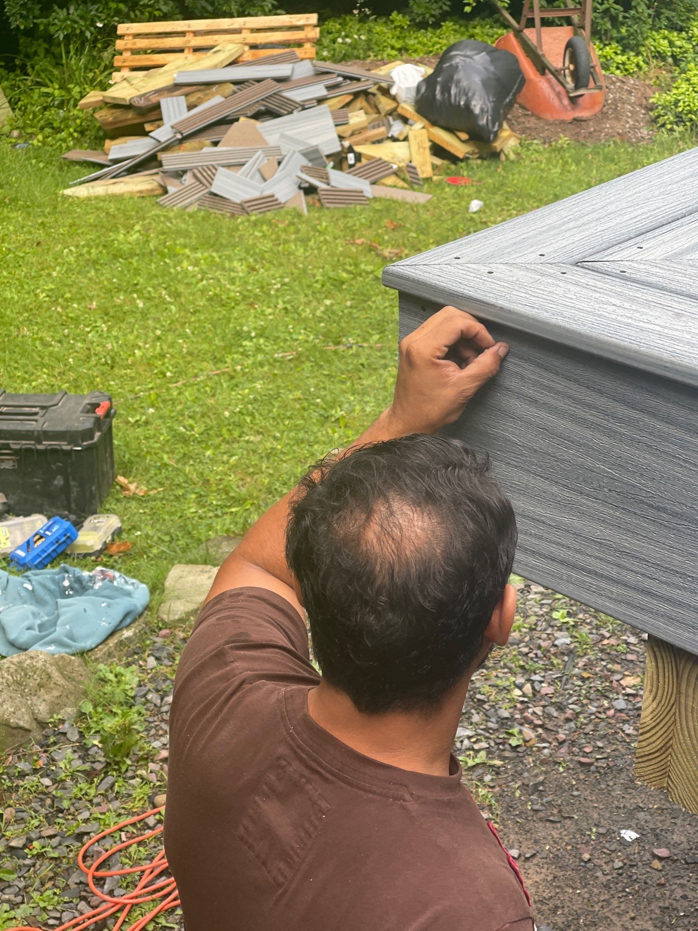 Raised Gray Composite Deck and Staircase Construction in Pocono Summit, PA by Herts Roofing & Construction
