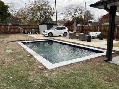 Modern Pool with Dark Interior and Deck Jets