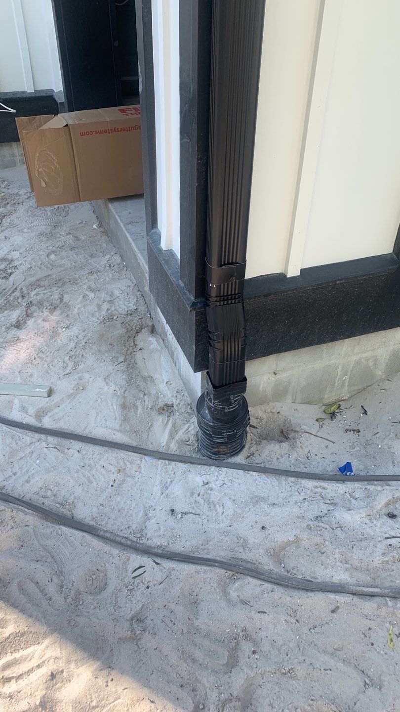 Seamless Gutter Installation Using Black Half Round Seamless Gutters by Gutter Professors