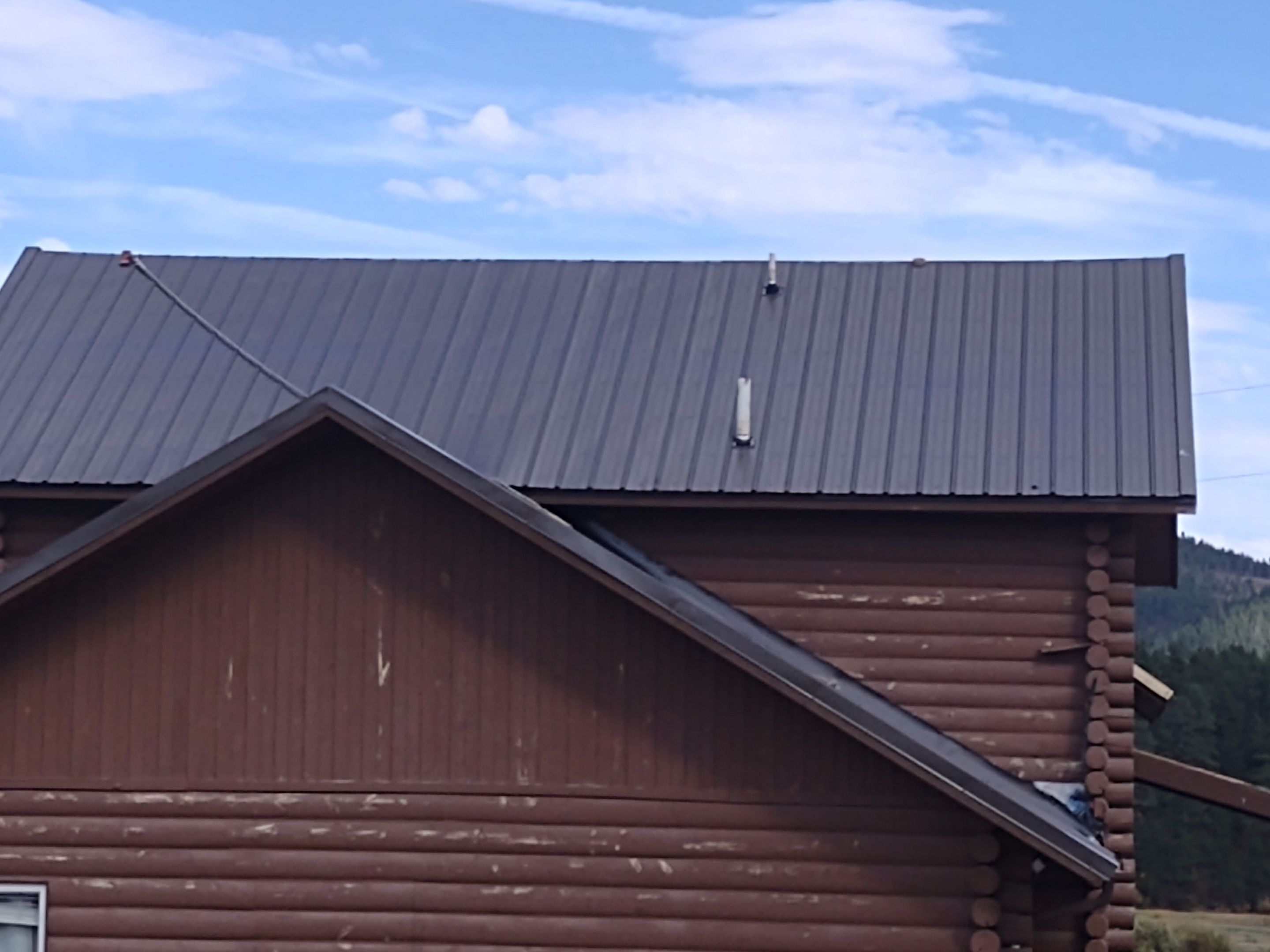 Hill Country Guest Ranch using Steel Roofing, Gutters, Log Cabin Staining by Lightning Exteriors