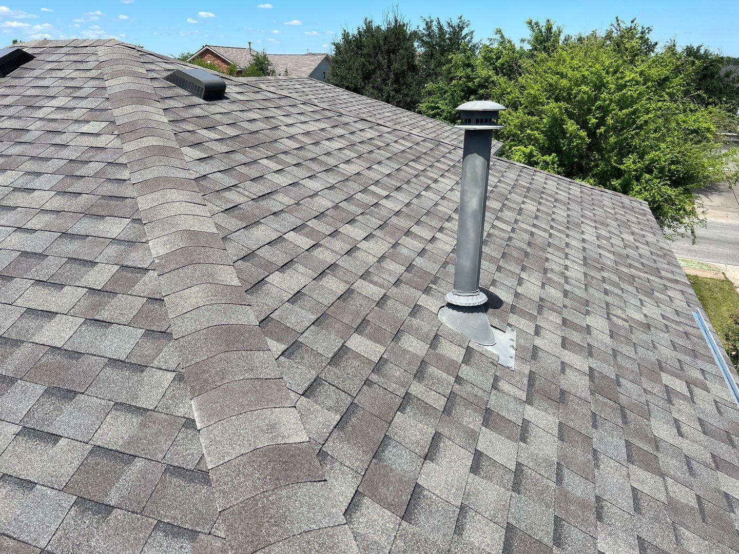 Wind damaged roof replacement by Oakwood Roofing and Construction, LLC