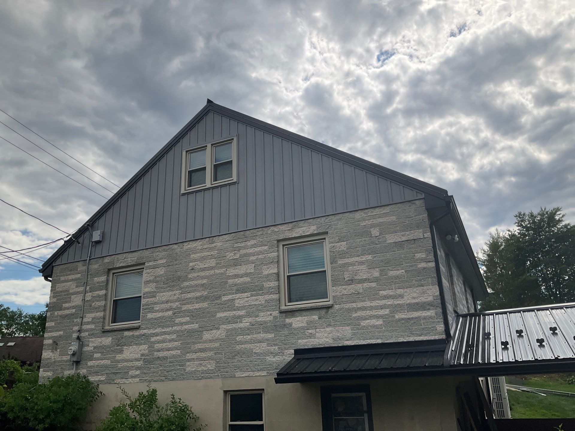 Metal Roofing, Board & Batten Siding, and Entry Door Transformation by Esh Builders