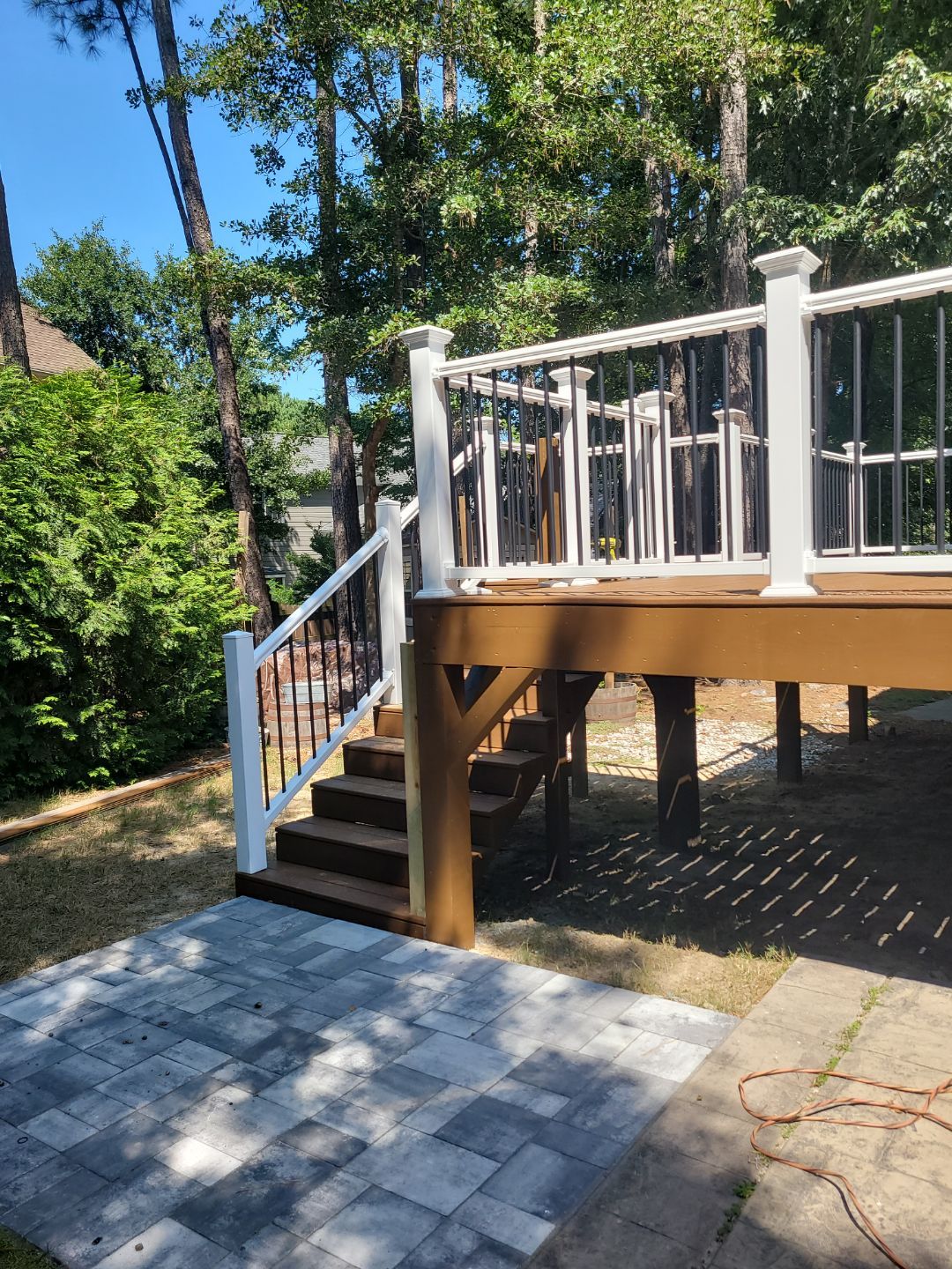 Fuquay-Varina Outdoor Upgrade – Composite Deck & Paved Landing by Elite Remodeling and Design LLC