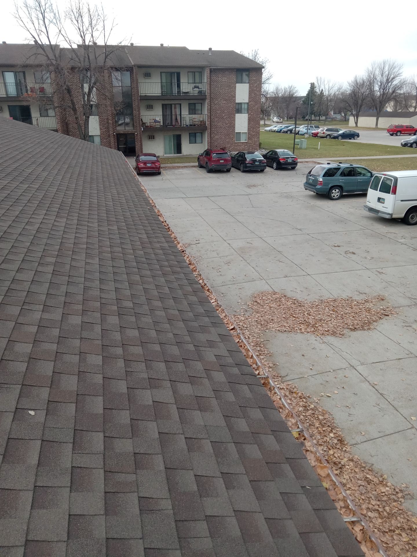 Commercial gutter cleaning North Dakota before photo with filled gutters
