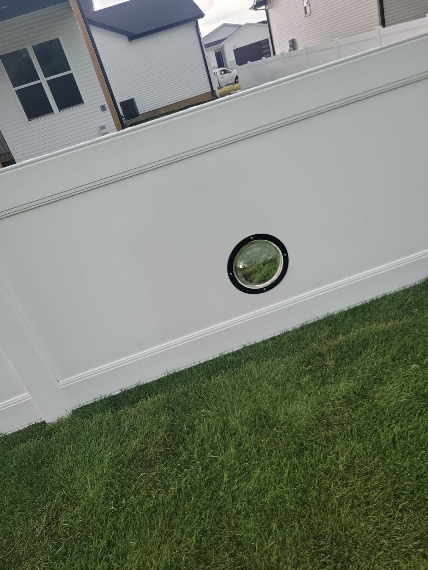 White Vinyl Privacy Fence With Pet Window in Cedar Falls by Perfect Picket Fence and Stain