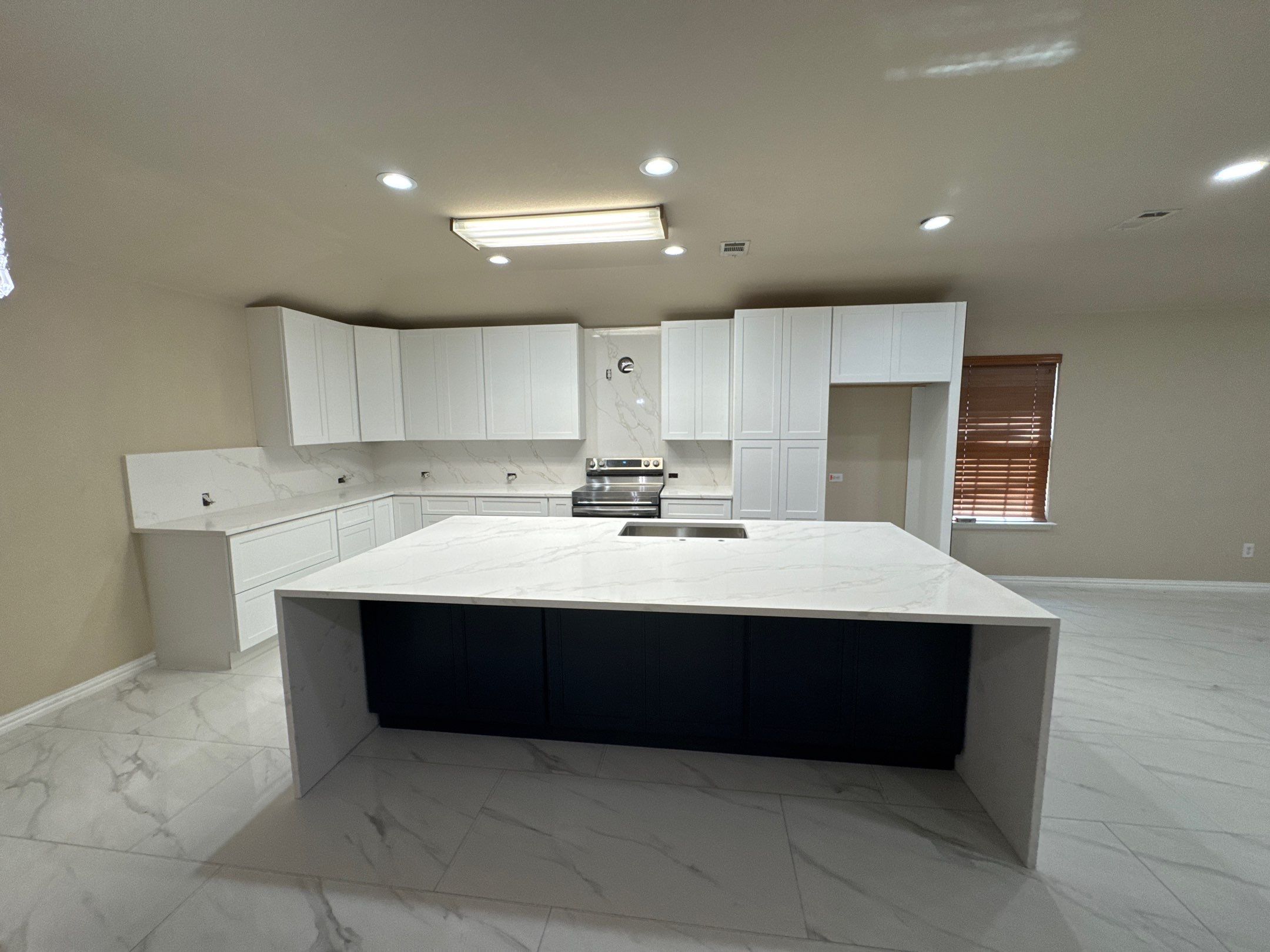 Luxury Focal Point: Full Kitchen Remodel with Double Waterfall Island by Tibi Soli LLC