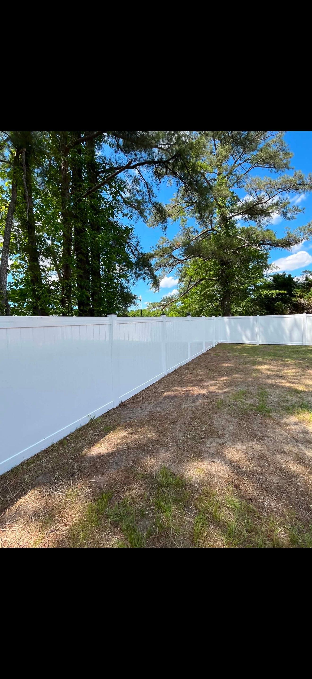 White Vinyl Privacy Fence with Solar Post Caps in Goldsboro by Superior Fence and Rail