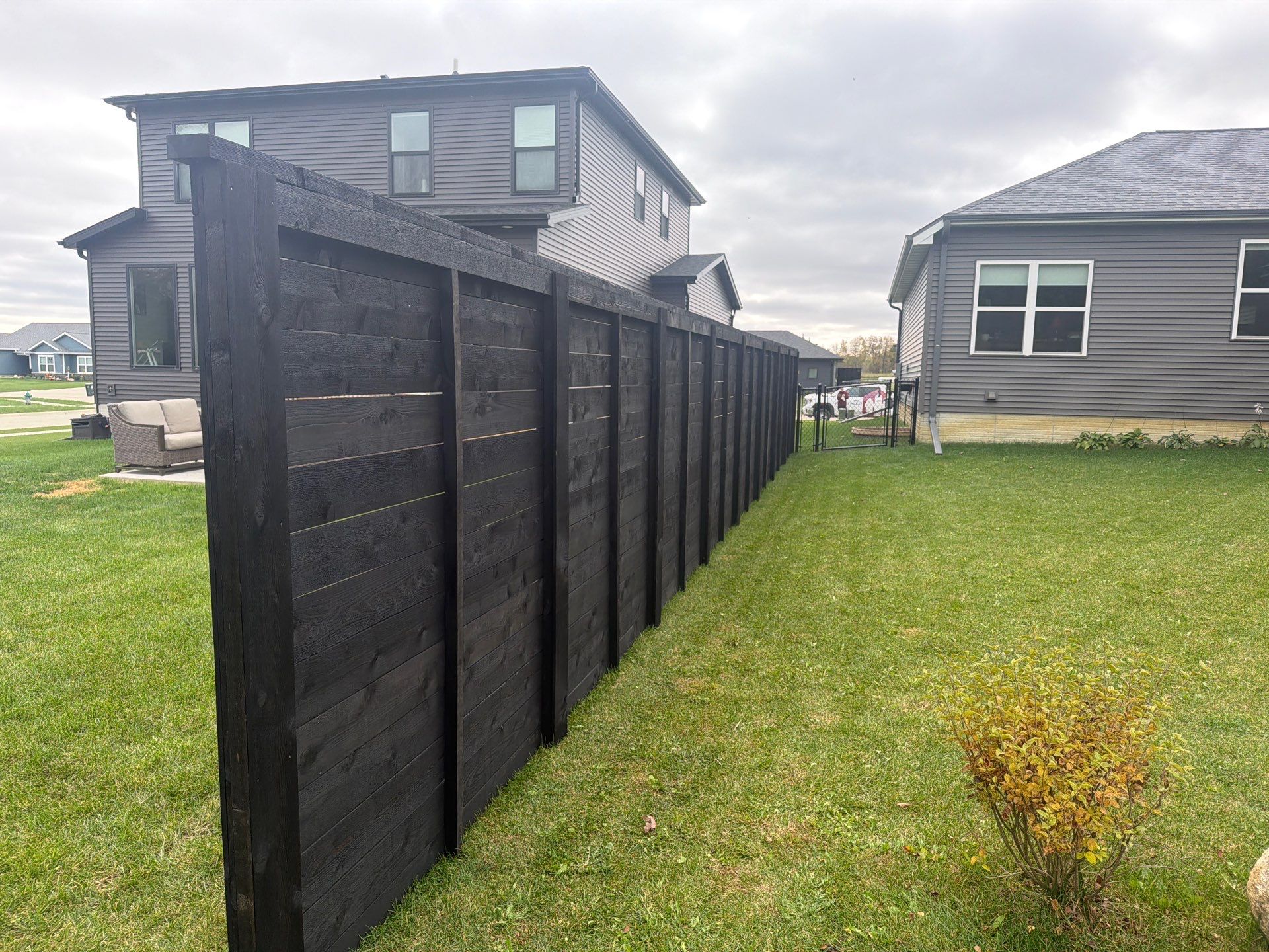 Modern Horizontal Wood Privacy Fence Installation in Cedar Falls by Perfect Picket Fence and Stain
