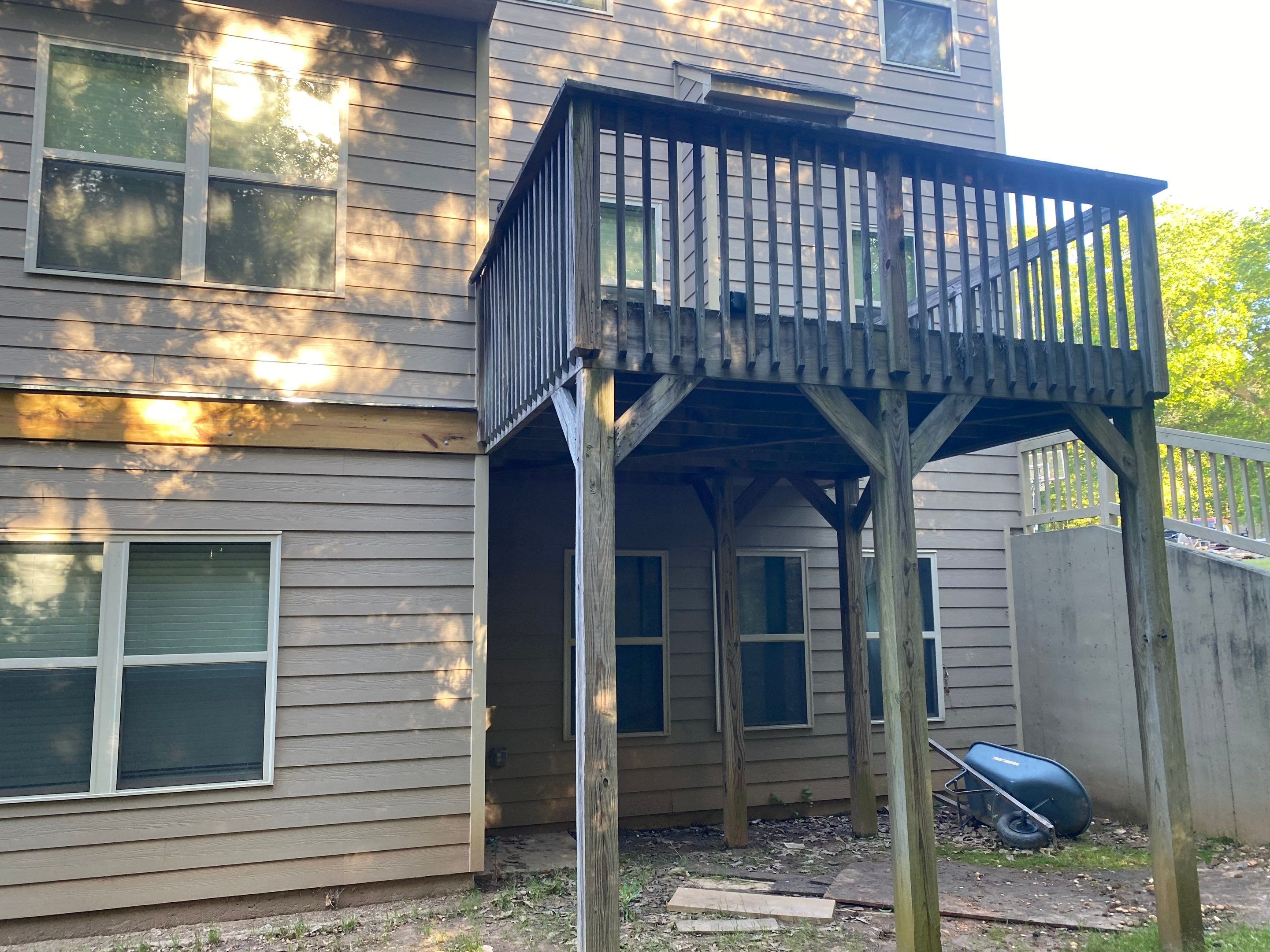 Custom Elevated Deck Replacement with White and Black Railings by Swift Home Renovations